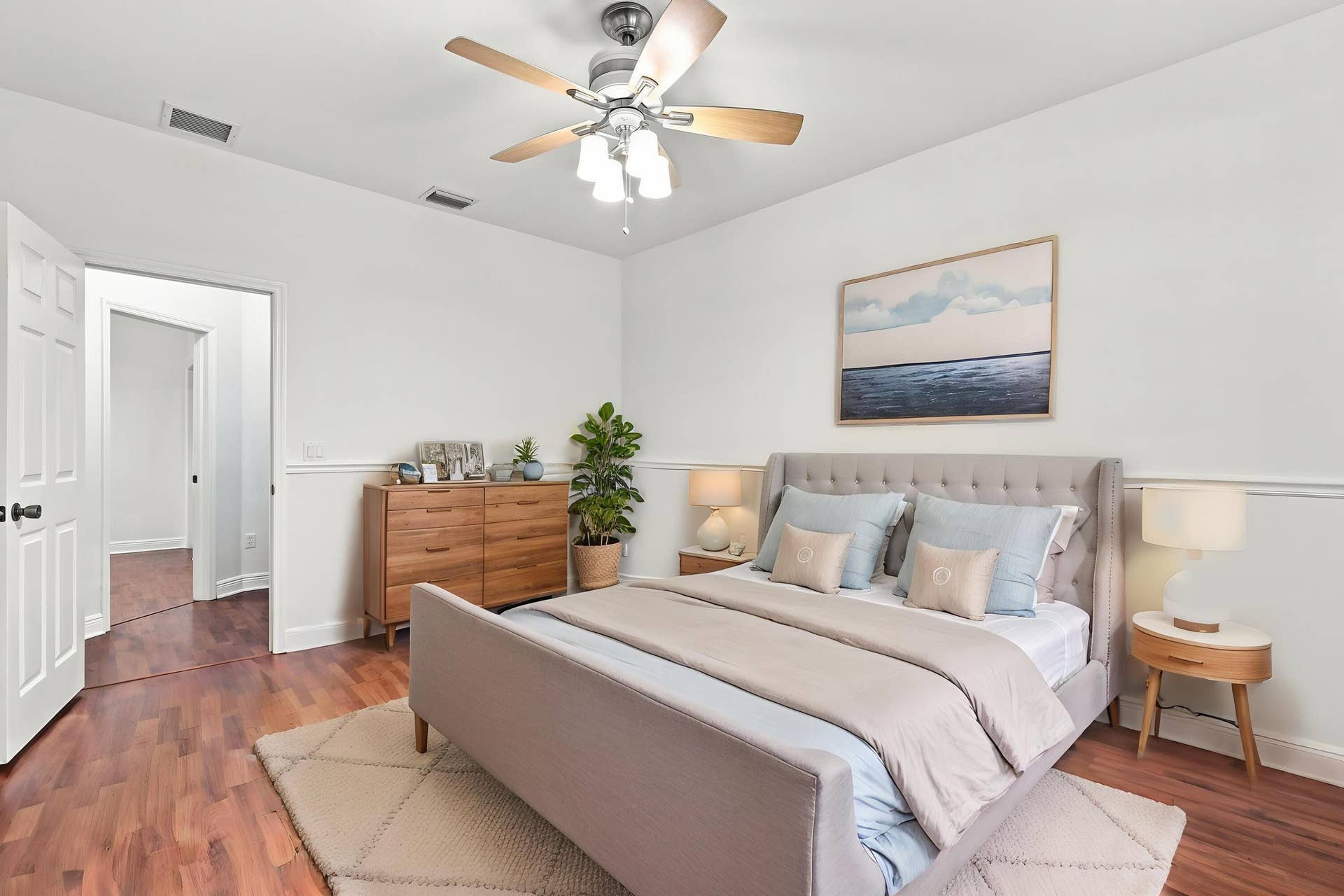 2107 Anchor Court, Fort Lauderdale, FL 33312 Spacious primary suite featuring warm wood flooring, abundant natural light, a large window overlooking lush greenery, and direct access to the private ensuite bathroom. The generous layout provides plenty of space and creates a comfortable private retreat.