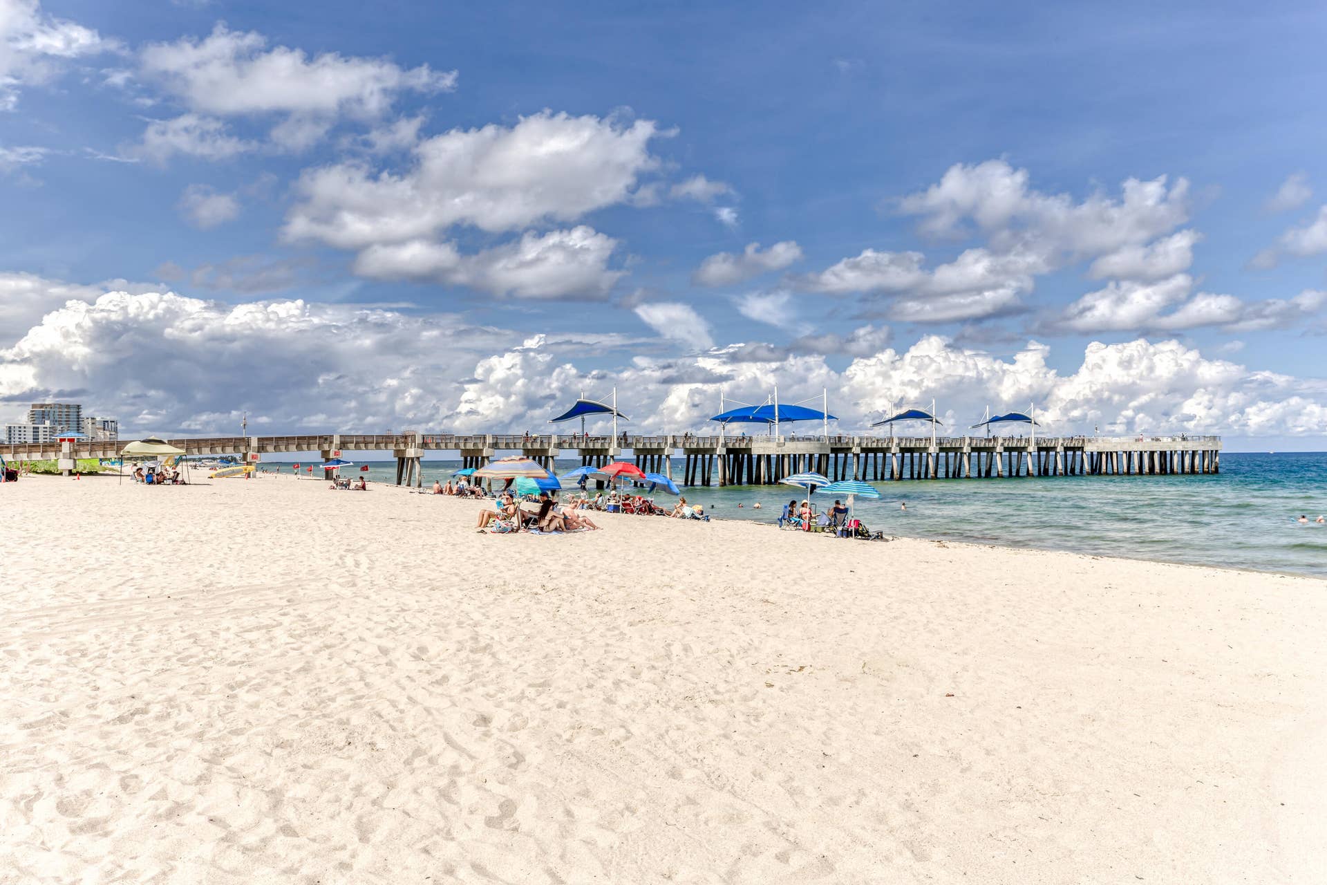 3224 NE 4th Street, Pompano Beach, FL 33062 Expansive white sand beach with clear blue water and a prominent pier structure
