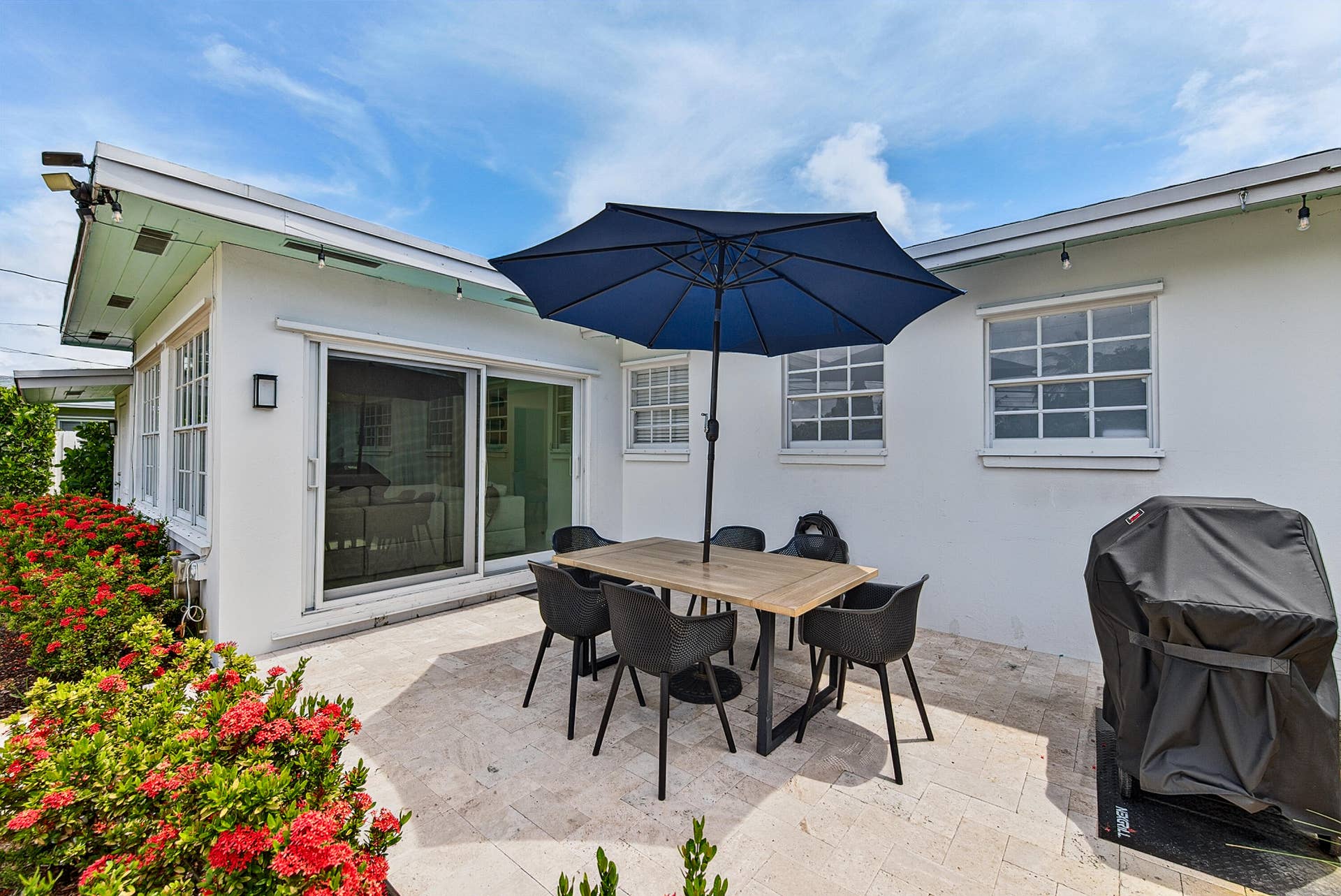 Paved patio area with impact sliding glass door access