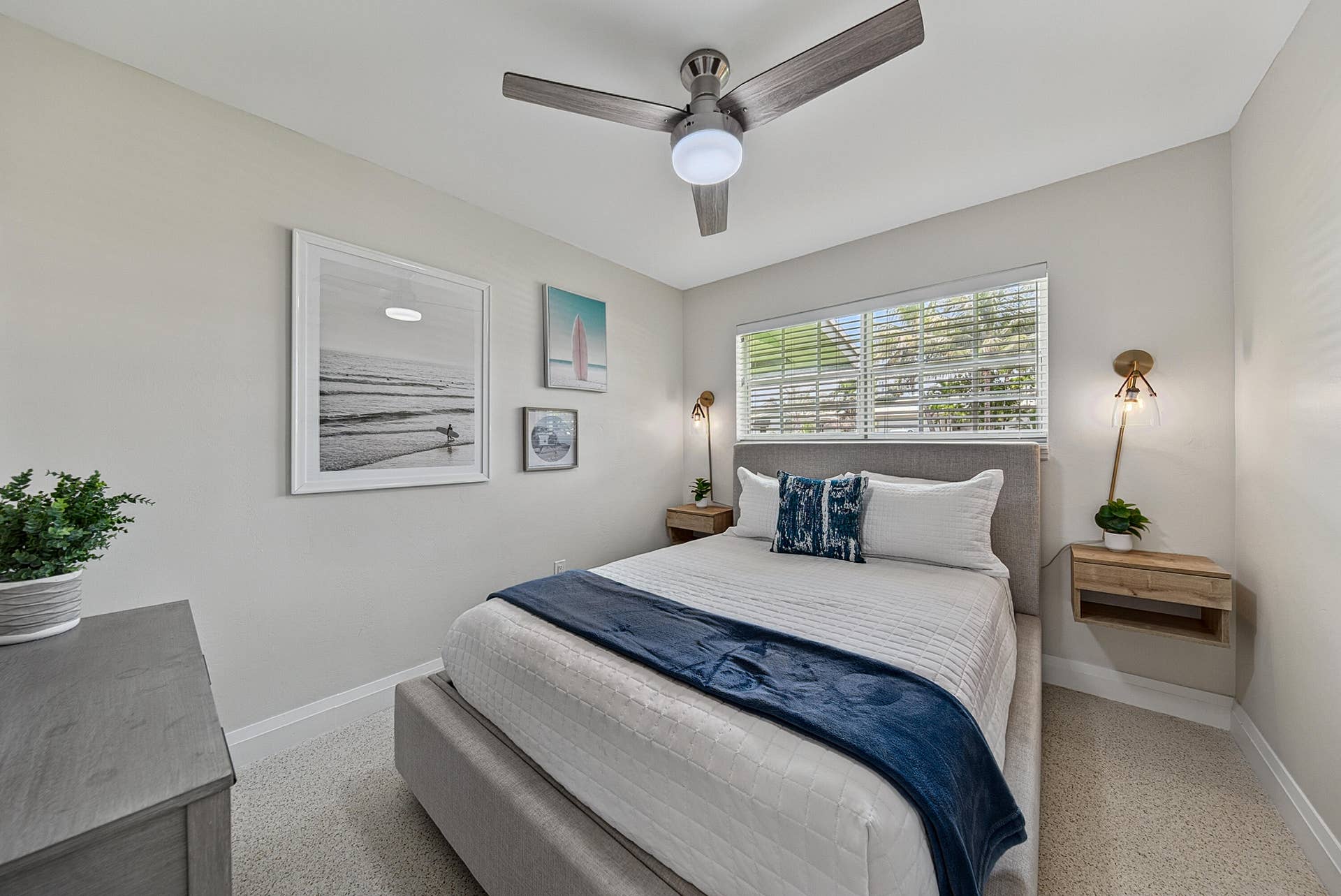 Recessed lighting, ceiling fan with integrated light, window with blinds, wall-mounted sconces, and floating wood-finish nightstands