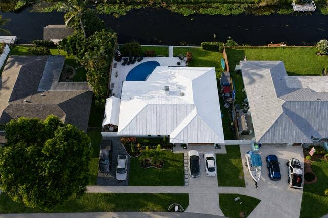 1201 SW 25TH Avenue, Boynton Beach, FL 33426 This impressive aerial view showcases the home's beautifully landscaped curb appeal, two driveways, and friendly neighbors.