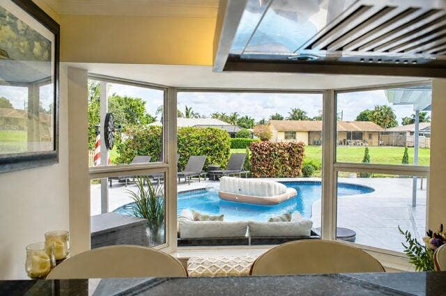1201 SW 25TH Avenue, Boynton Beach, FL 33426 Pool view From Kitchen Bay Window. Enjoy beautiful pool and backyard views right from your kitchen, bringing the outdoors into everyday living.