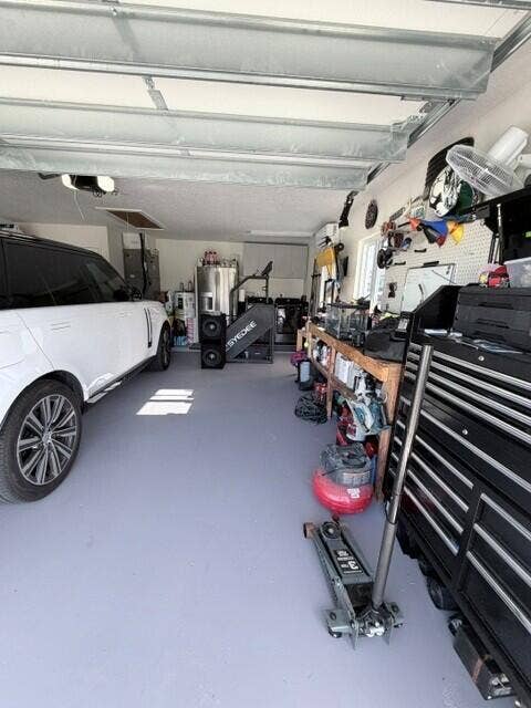 1201 SW 25TH Avenue, Boynton Beach, FL 33426 This Air conditioned garage features a dedicated workstation and ample room for tolls, storage, and everyday projects. A convenient laundry area with washer and dryer adding functi9onality while keeping household tasks organized and easily accessible.