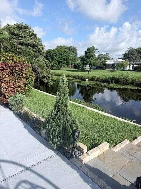 1201 SW 25TH Avenue, Boynton Beach, FL 33426 Direct canal frontage, mature landscaping, and thoughtfully designed outdoor areas create a private and peaceful backyard.