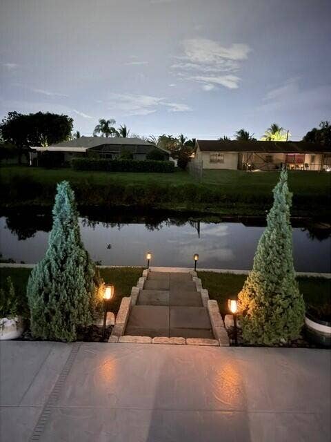 1201 SW 25TH Avenue, Boynton Beach, FL 33426 Enjoy the seamless connection to the outdoors while relaxing on your outside couch overlooking the calm water view.