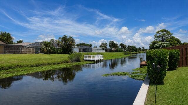 1201 SW 25TH Avenue, Boynton Beach, FL 33426 Enjoy long, peaceful canal views directly from the property's seawall, creating a serene waterfront backdrop. This navigable freshwater canal is ideal for Kayaking, fishing, and embracing the relaxed yet fun waterfront lifestyle.