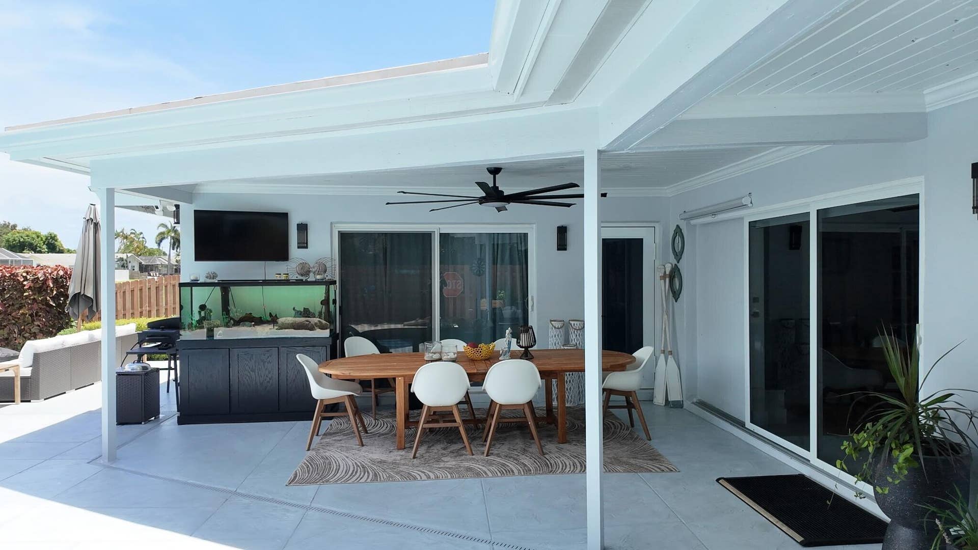1201 SW 25TH Avenue, Boynton Beach, FL 33426 This spacious covered patio area offers the perfect setting for outdoor dining and entertaining while overlooking the peaceful waterfront canal.