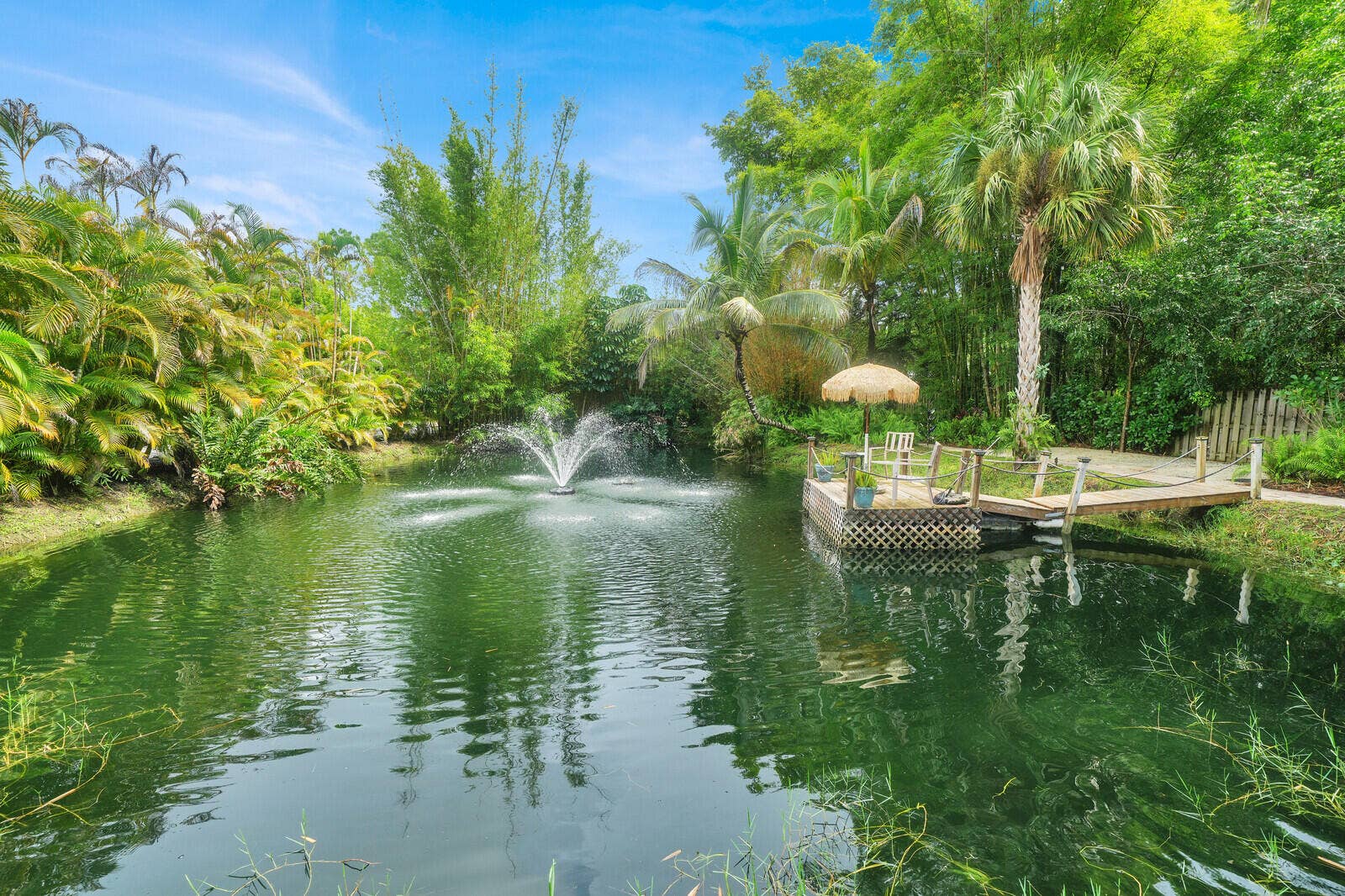 13432 153RD Road N, Jupiter, FL 33478 Pond with aerator sprinkler and dock