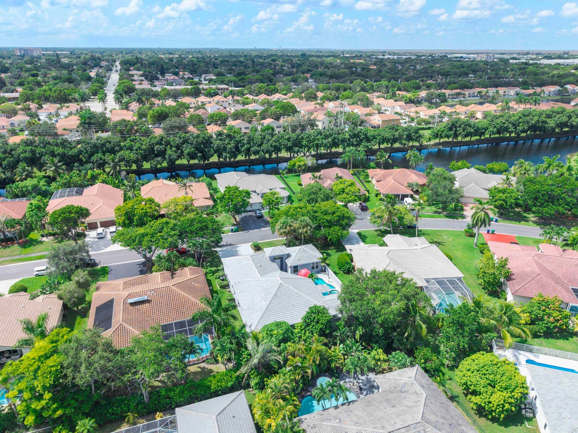 4862 Kensington Circle, Coral Springs, FL 33076 Aerial perspective showcasing a residential area with varied rooflines and lush landscaping