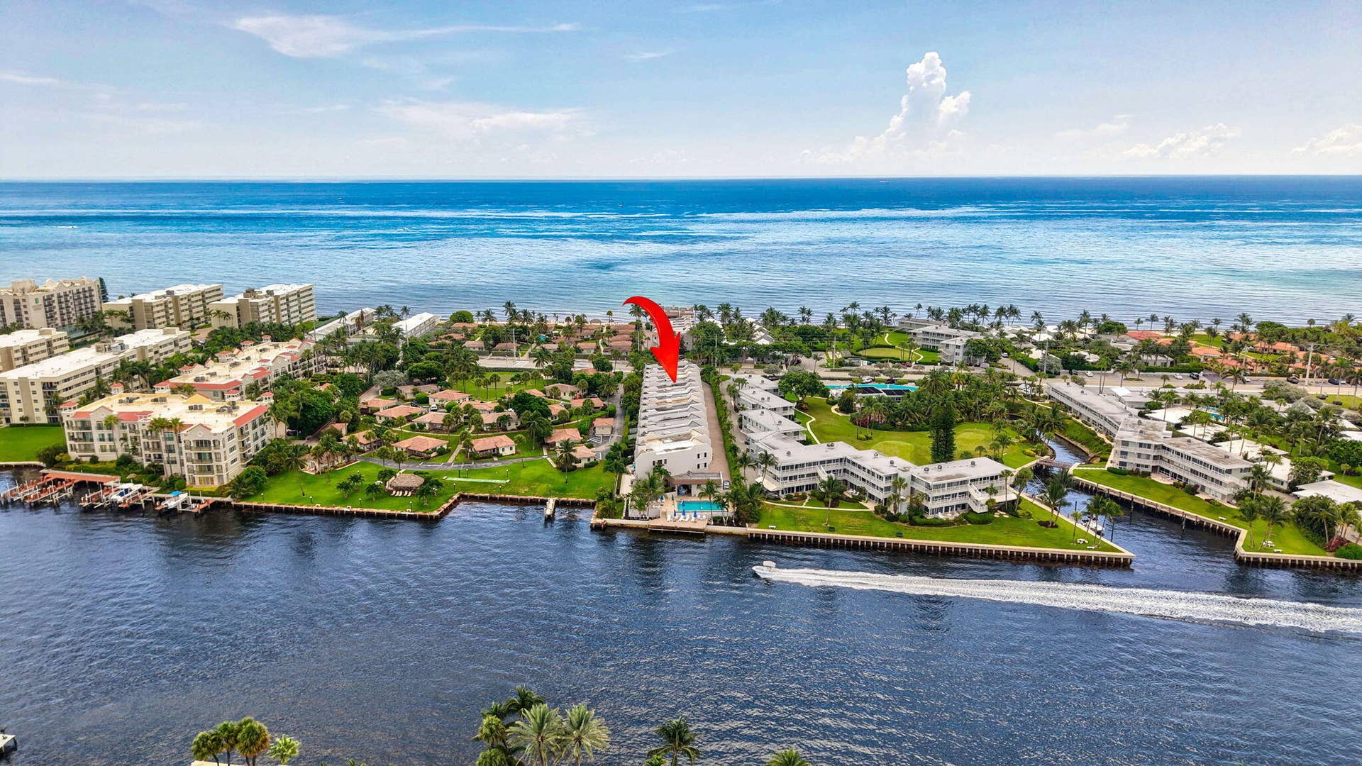 1222 Hillsboro Mile, #15, Hillsboro Beach, FL 33062 Waterfront property featuring direct ocean access, a bright blue ocean backdrop, and surrounded by canals