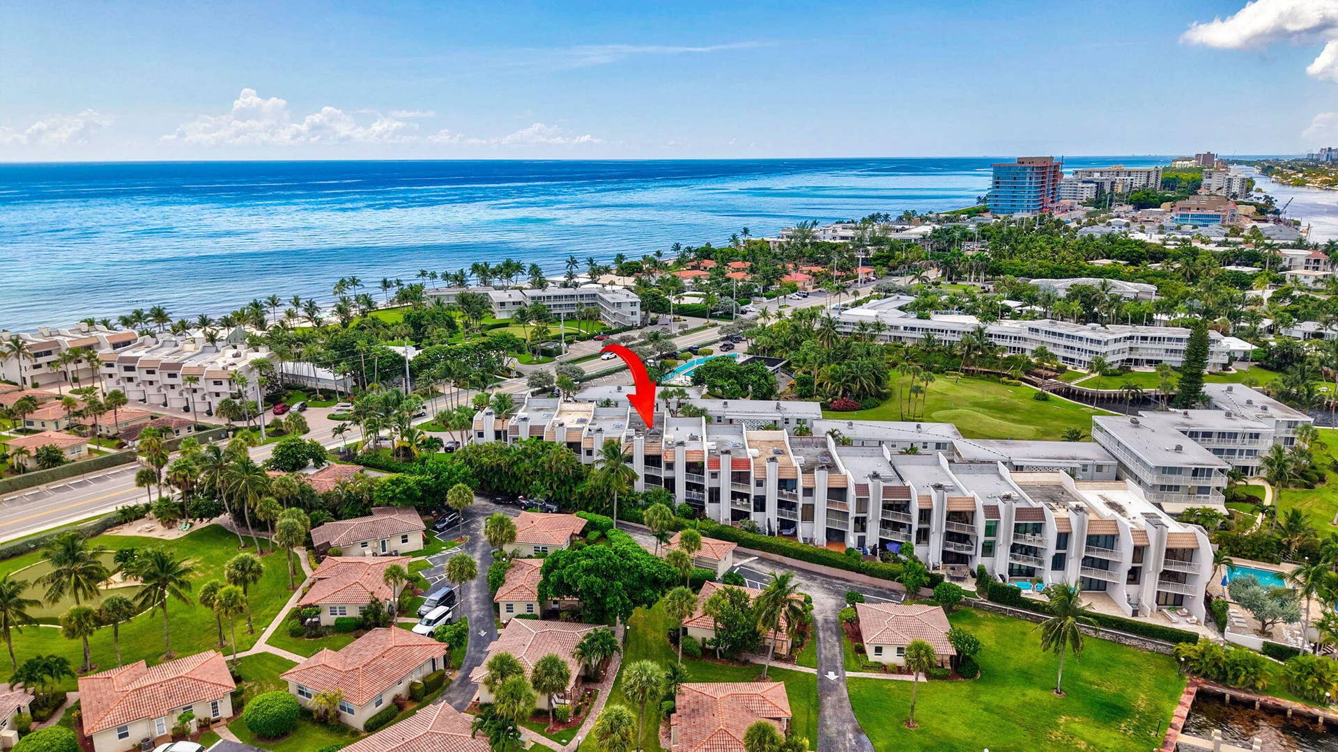 1222 Hillsboro Mile, #15, Hillsboro Beach, FL 33062 Coastal condominium community with multiple buildings, lush landscaping, and integrated swimming pool