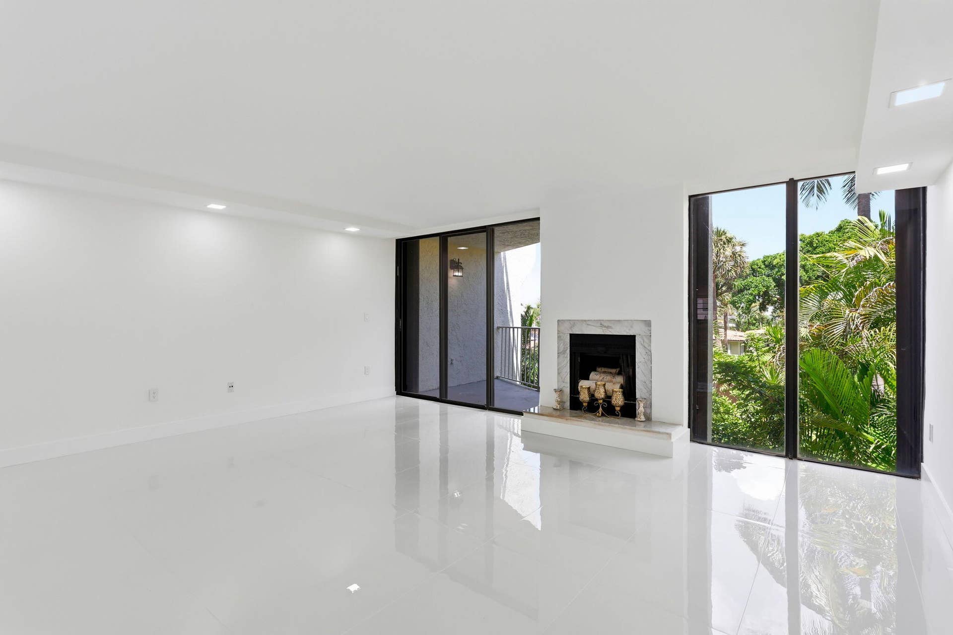 1222 Hillsboro Mile, #15, Hillsboro Beach, FL 33062 Spacious interior featuring white tile flooring, recessed lighting, and a white marble fireplace