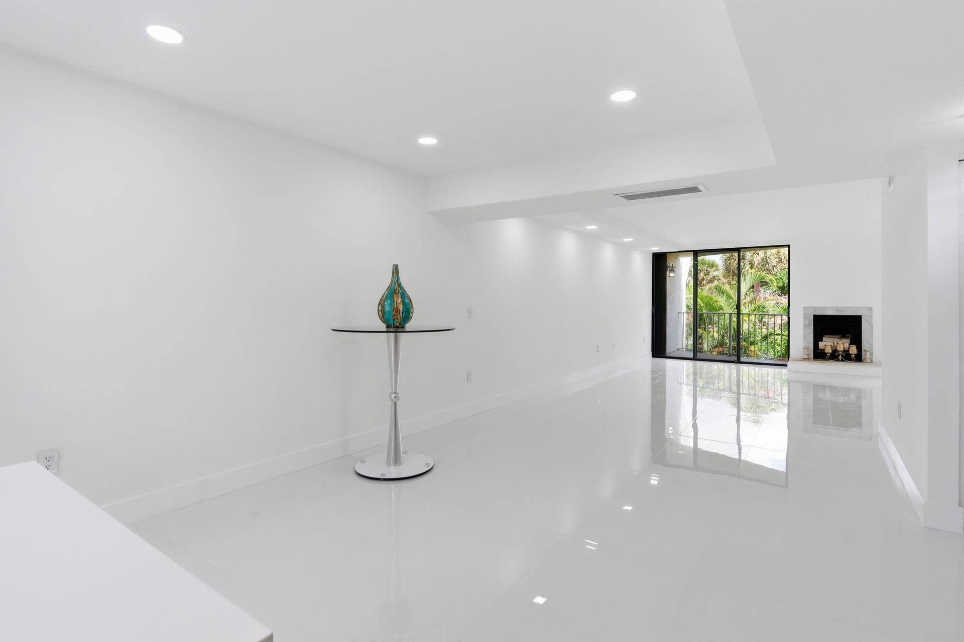 1222 Hillsboro Mile, #15, Hillsboro Beach, FL 33062 Recessed lighting, polished tile flooring, white walls, and a fireplace with a stone surround