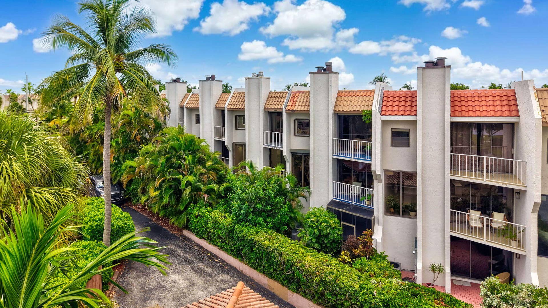 1222 Hillsboro Mile, #15, Hillsboro Beach, FL 33062 Multi-level townhome featuring white stucco exterior, terracotta roof tiles, and multiple balconies with white railings
