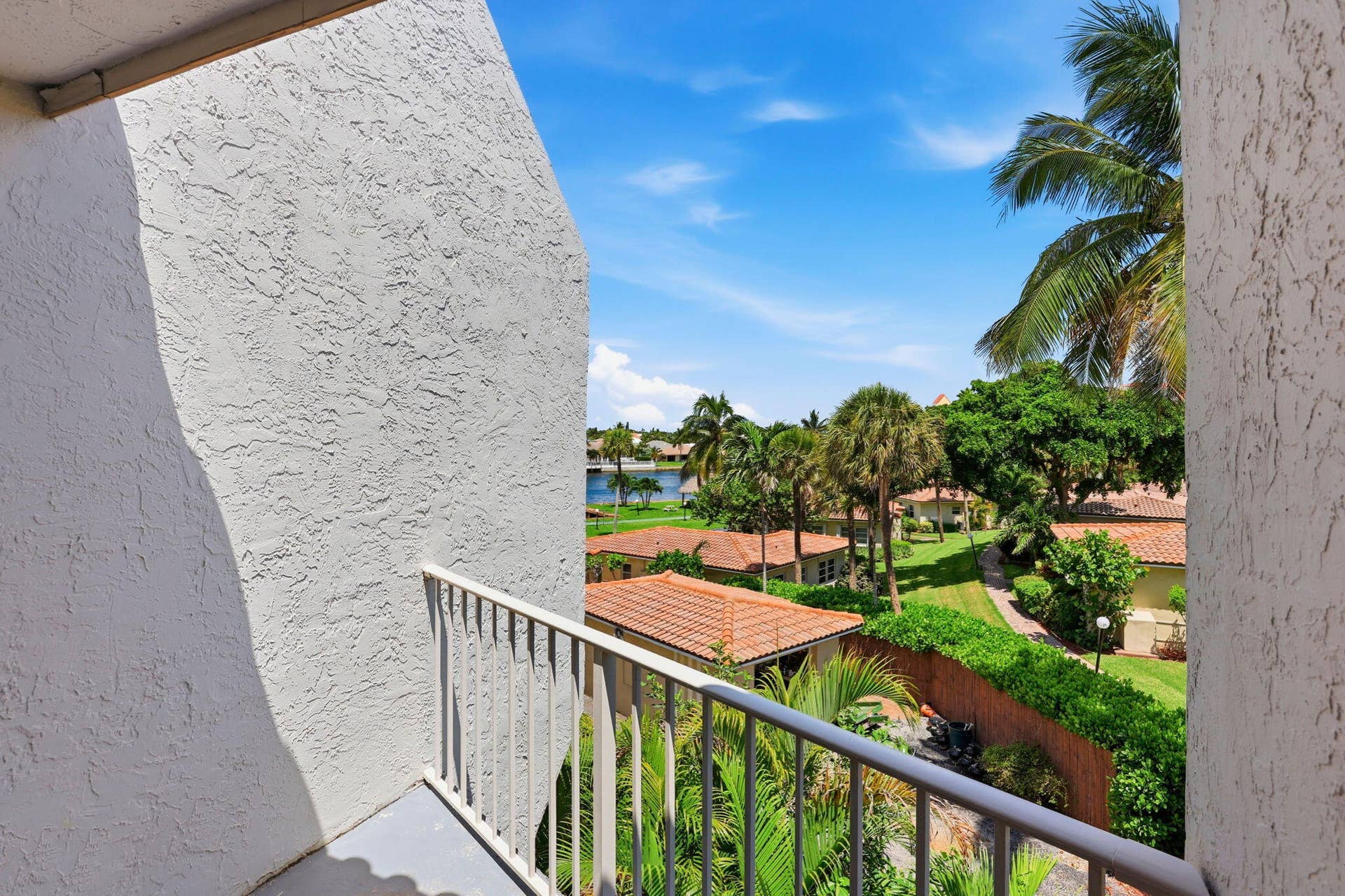 1222 Hillsboro Mile, #15, Hillsboro Beach, FL 33062 Balcony with a metal railing, stucco exterior, and a water feature