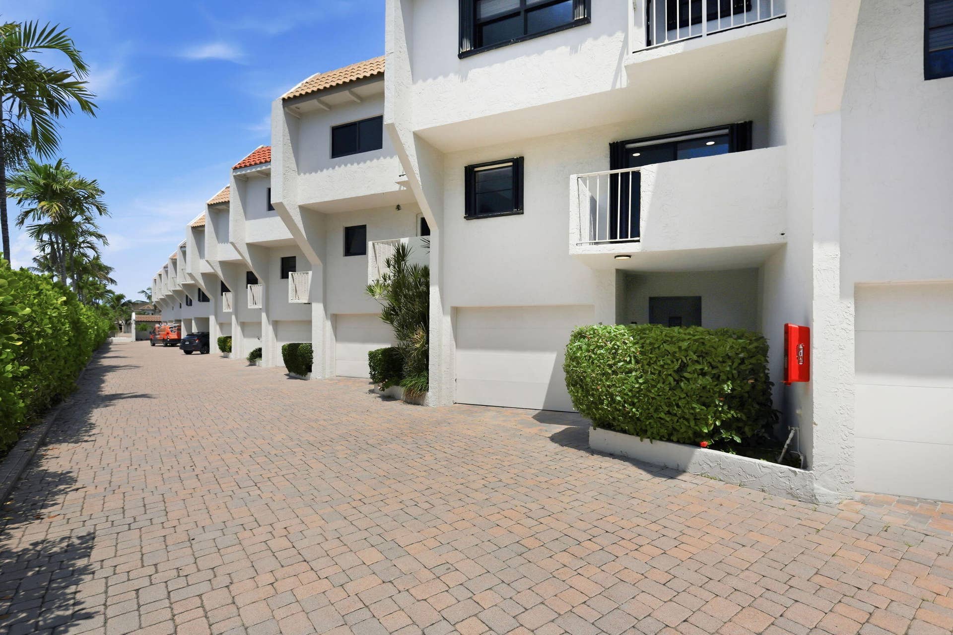 1222 Hillsboro Mile, #15, Hillsboro Beach, FL 33062 Stucco exterior with white finish, integrated private balconies, attached garages, and a paver driveway