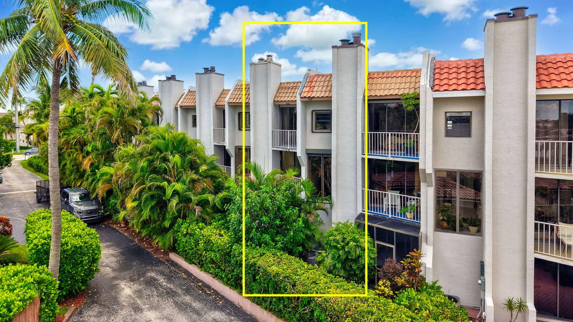 1222 Hillsboro Mile, #15, Hillsboro Beach, FL 33062 Stucco exterior with multiple balconies, tile roofing, and mature landscaping