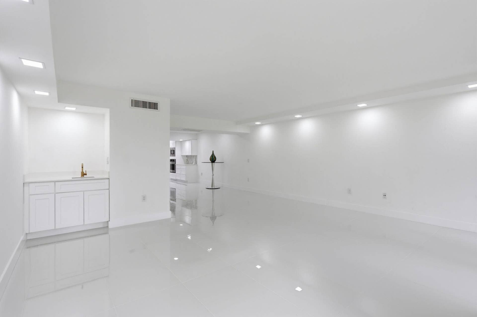 1222 Hillsboro Mile, #15, Hillsboro Beach, FL 33062 Expansive room featuring glossy tile flooring, recessed lighting, and a built-in wet bar with white cabinetry and a light-toned countertop