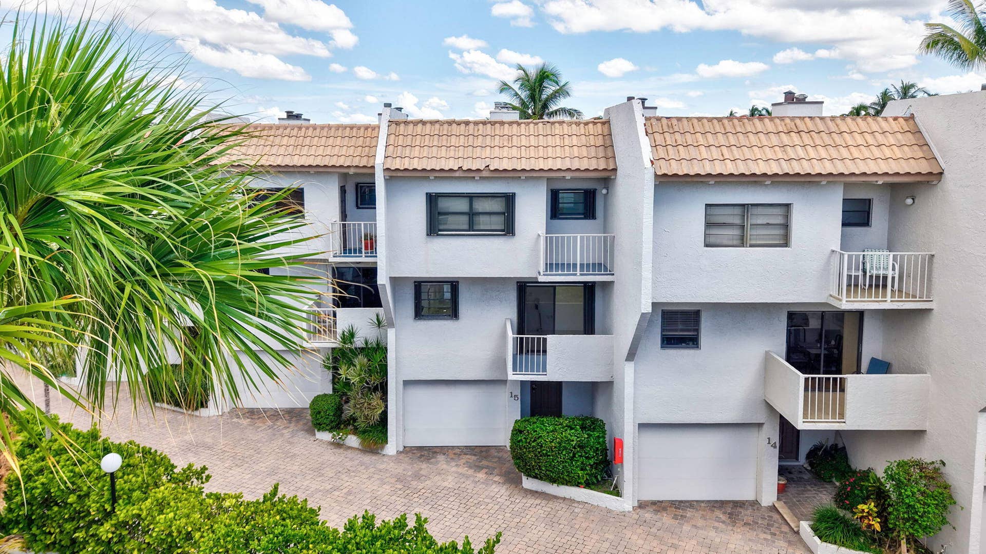 1222 Hillsboro Mile, #15, Hillsboro Beach, FL 33062 Multi-level exterior with tile roofing, private balconies, integrated garages, and mature landscaping