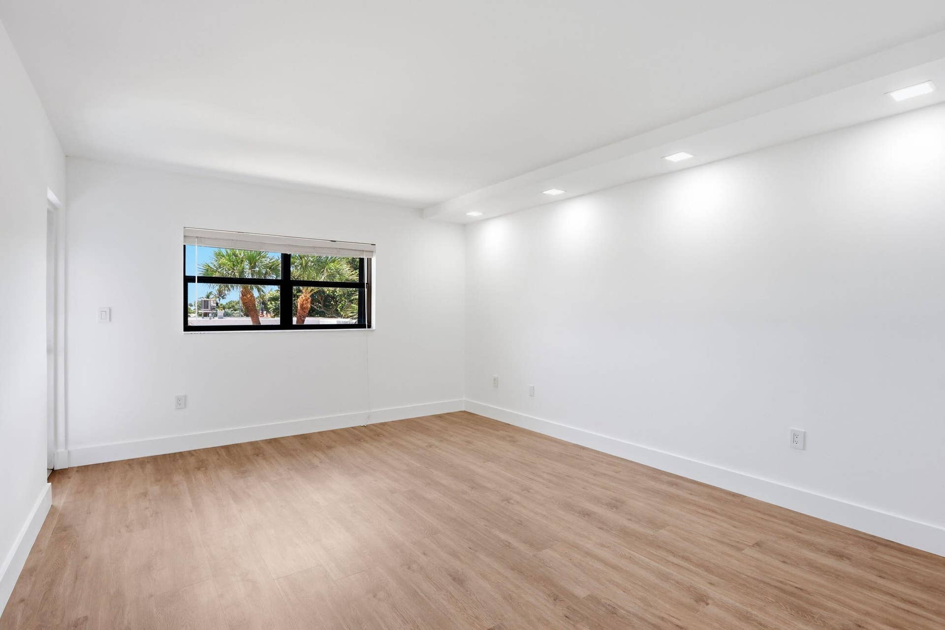 1222 Hillsboro Mile, #15, Hillsboro Beach, FL 33062 Recessed lighting, wood-finish flooring, white walls, black-framed window, window blinds