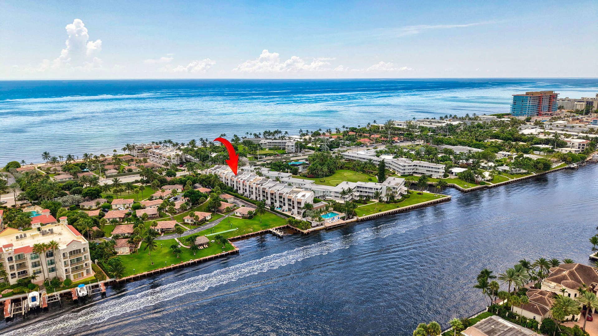 Waterfront property with canal and ocean access, surrounded by lush landscaping and residential structures