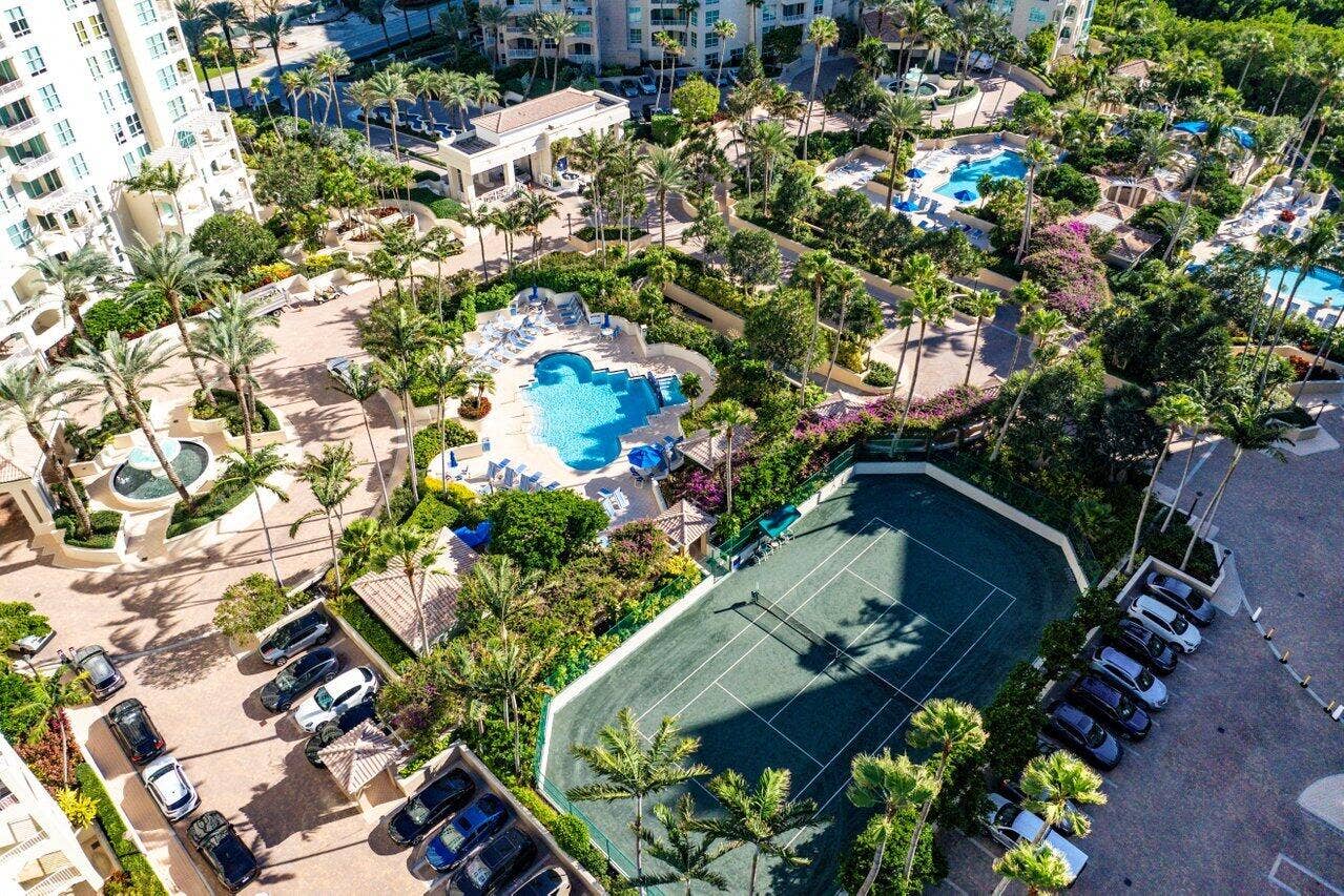 3700 S OCEAN Boulevard, #404, Highland Beach, FL 33487 Expansive grounds featuring multiple swimming pools, a tennis court, and lush landscaping
