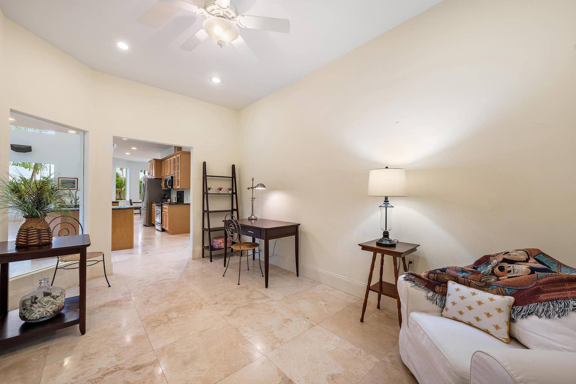Vaulted ceiling with recessed lighting and a ceiling fan