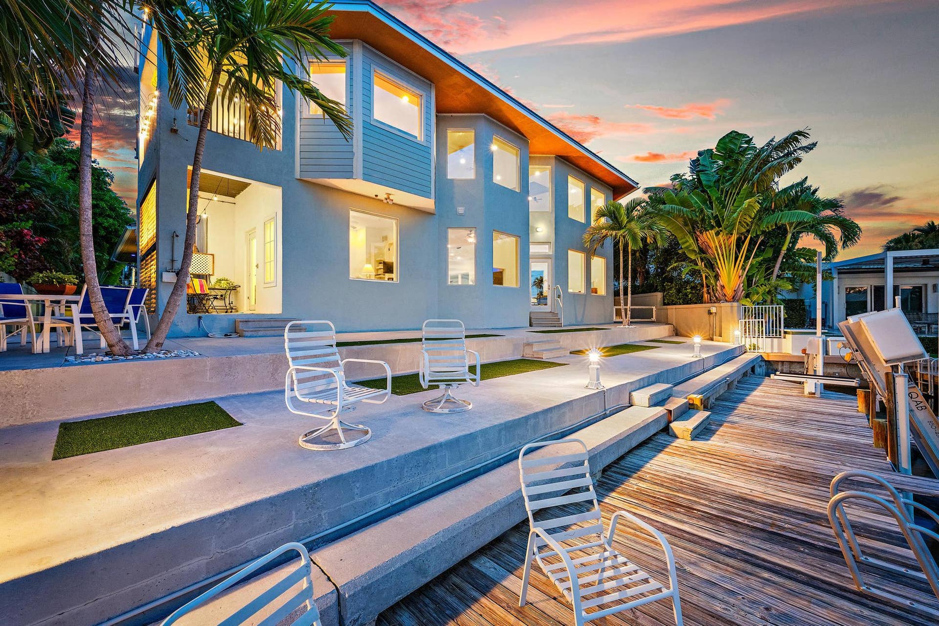 Multi-level concrete patio with integrated lighting and a wood-planked dock