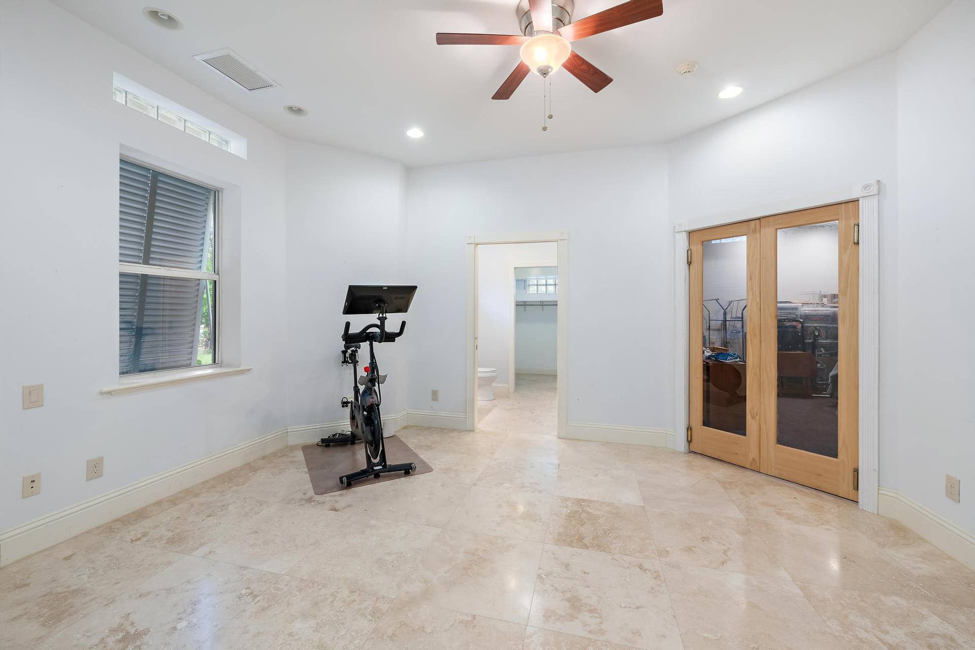 Travertine flooring, recessed lighting, and a ceiling fan with light fixture