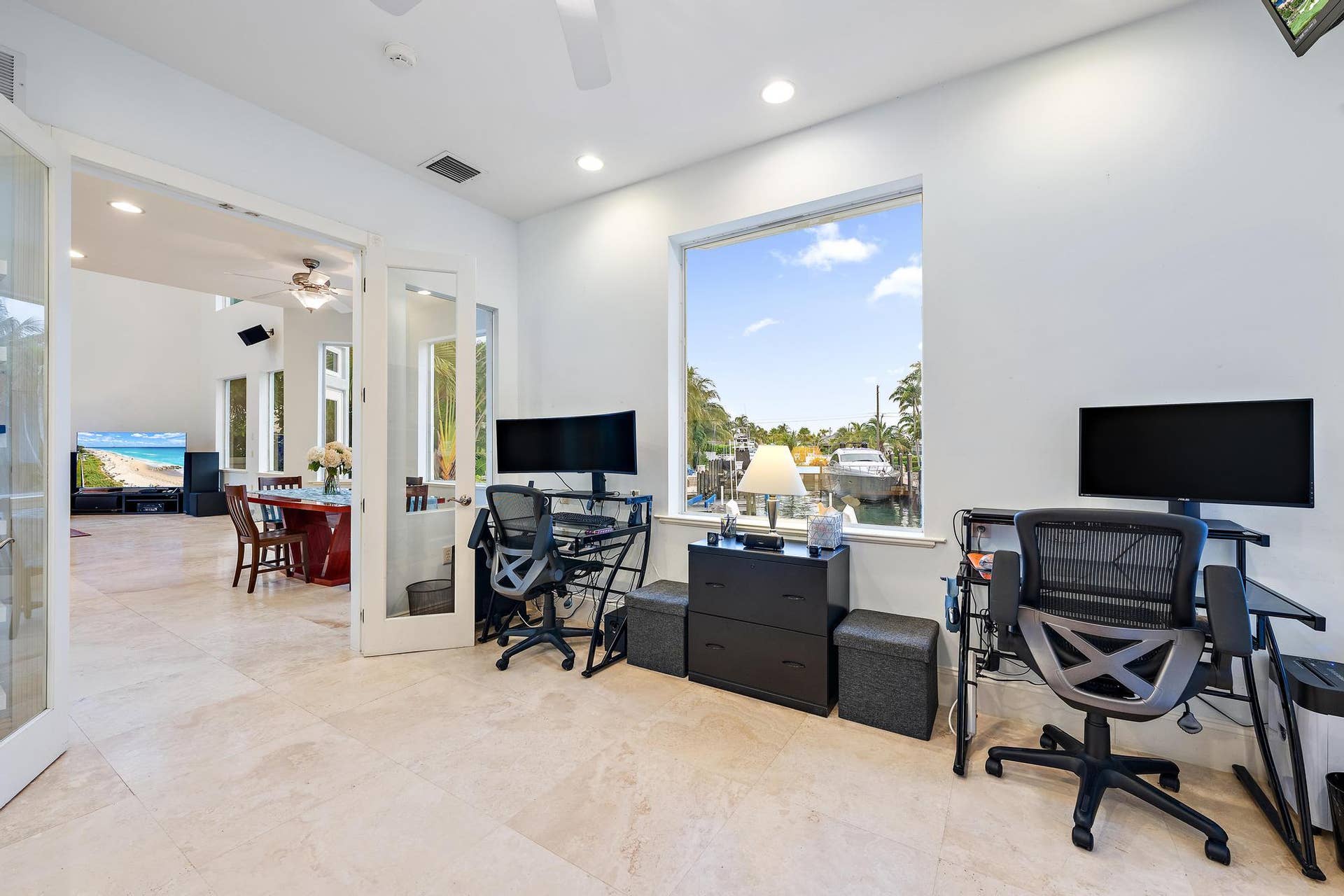 Expansive room featuring light-toned tile flooring and recessed lighting