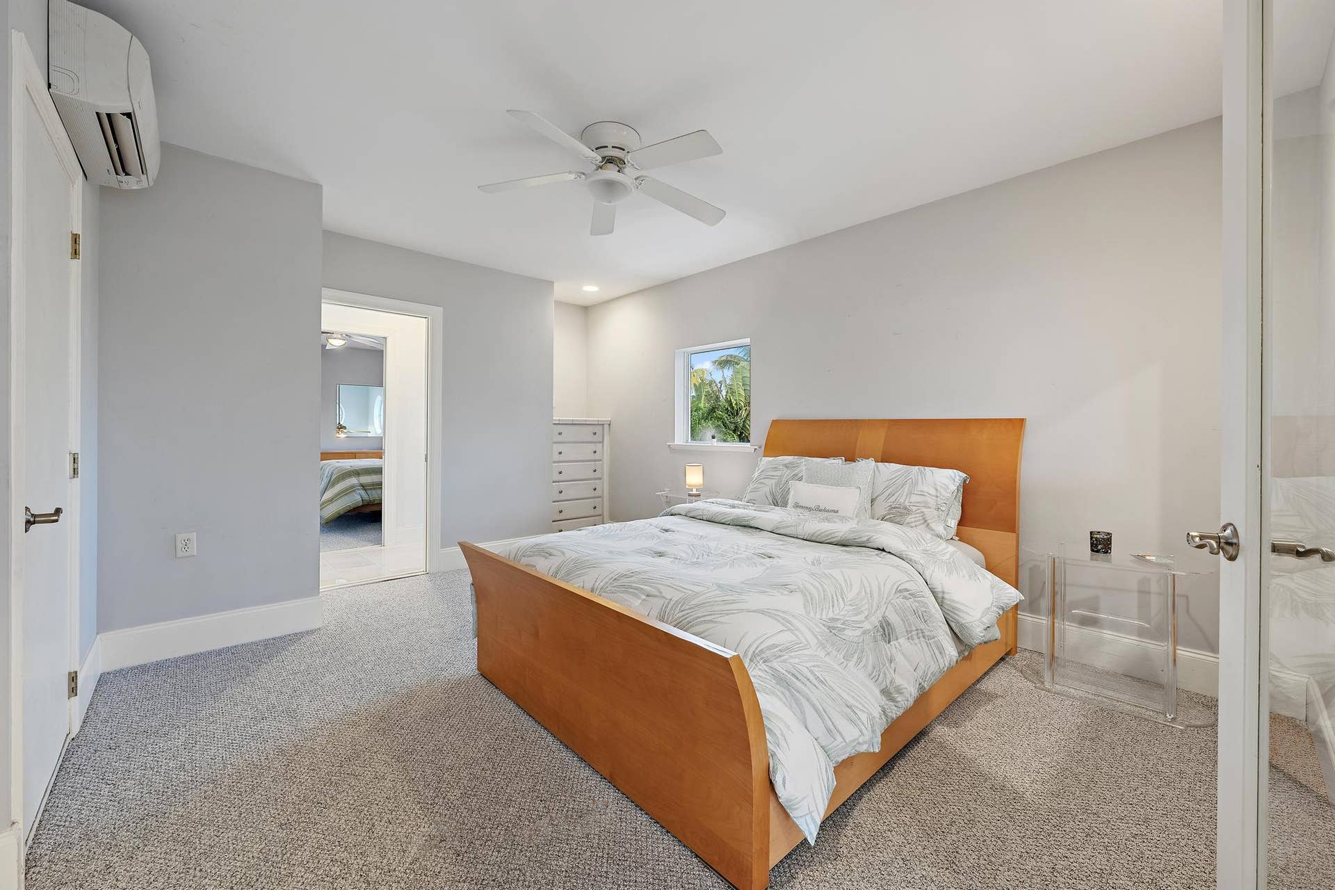 Wall-mounted split system, ceiling fan, recessed lighting, and carpeted flooring