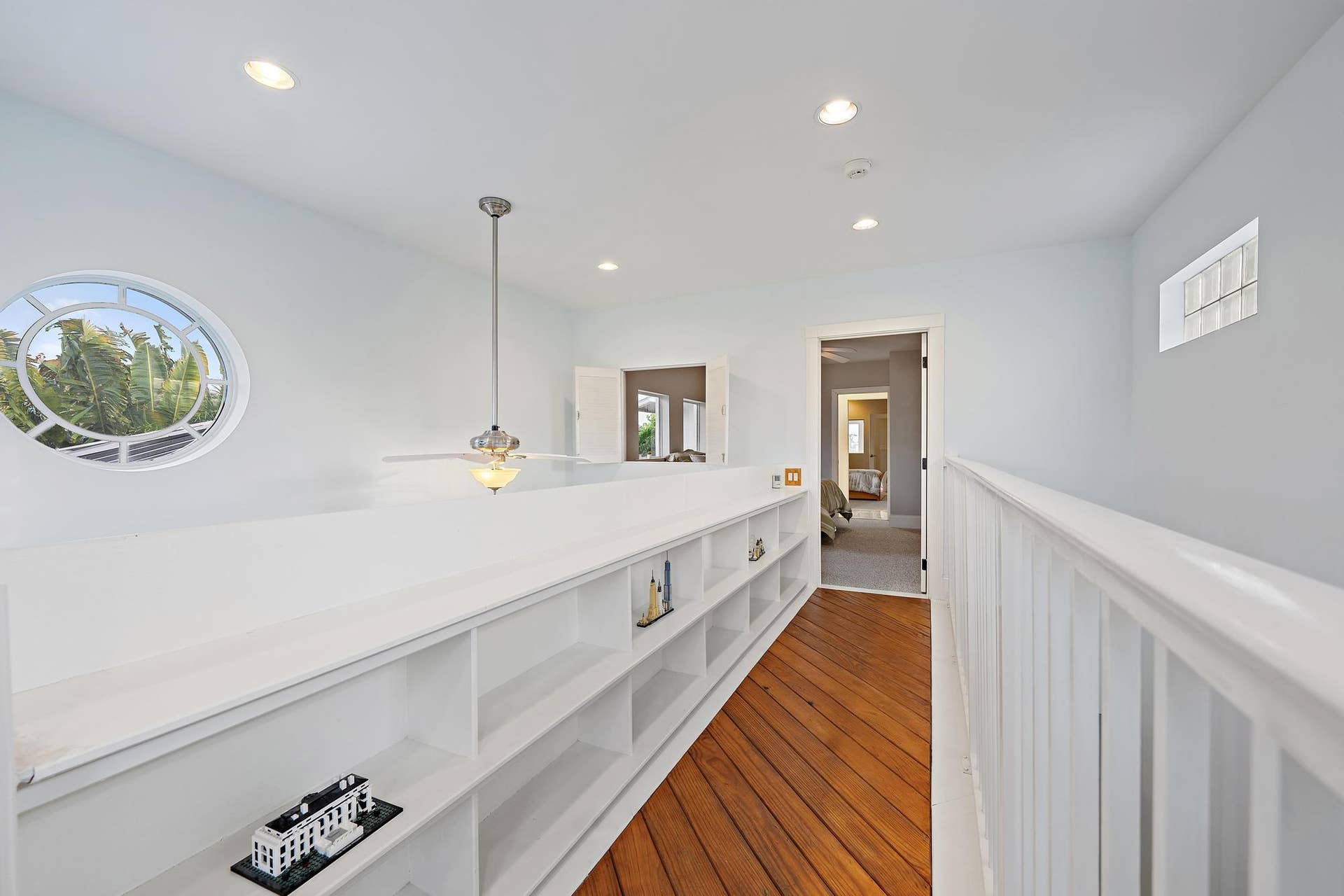 Wood-finish flooring, recessed lighting, and a distinctive oval window