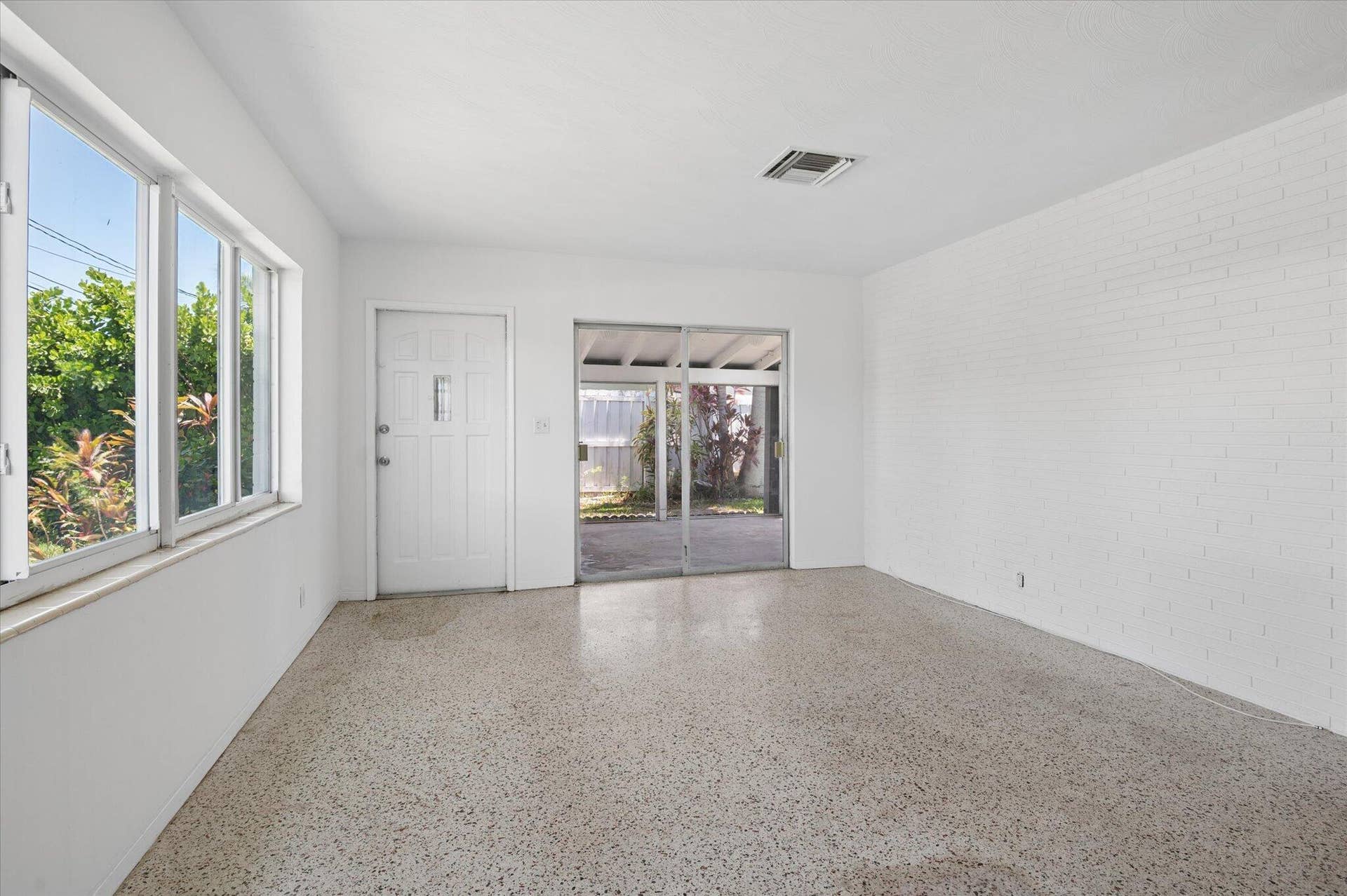 1158 Grant Street, Hollywood, FL 33019 Living Room with white brick wall
