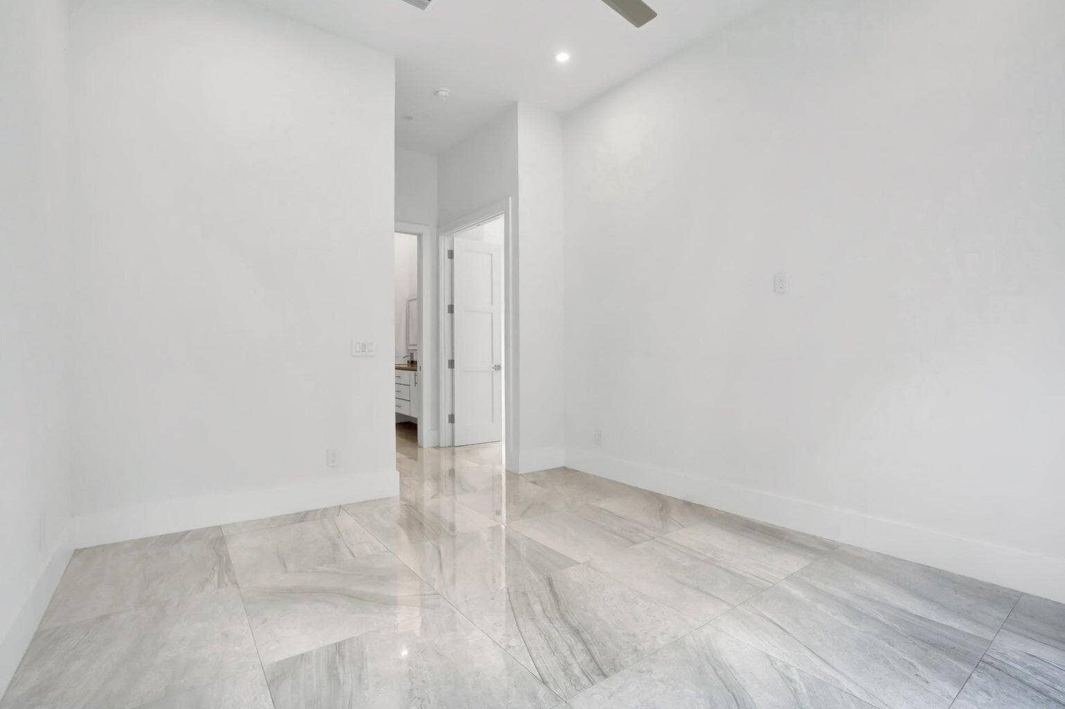2517 Oceanview Avenue E, Delray Beach, Delray Beach, FL 33444 Light gray large format floor tiling, recessed ceiling lighting, and a ceiling fan