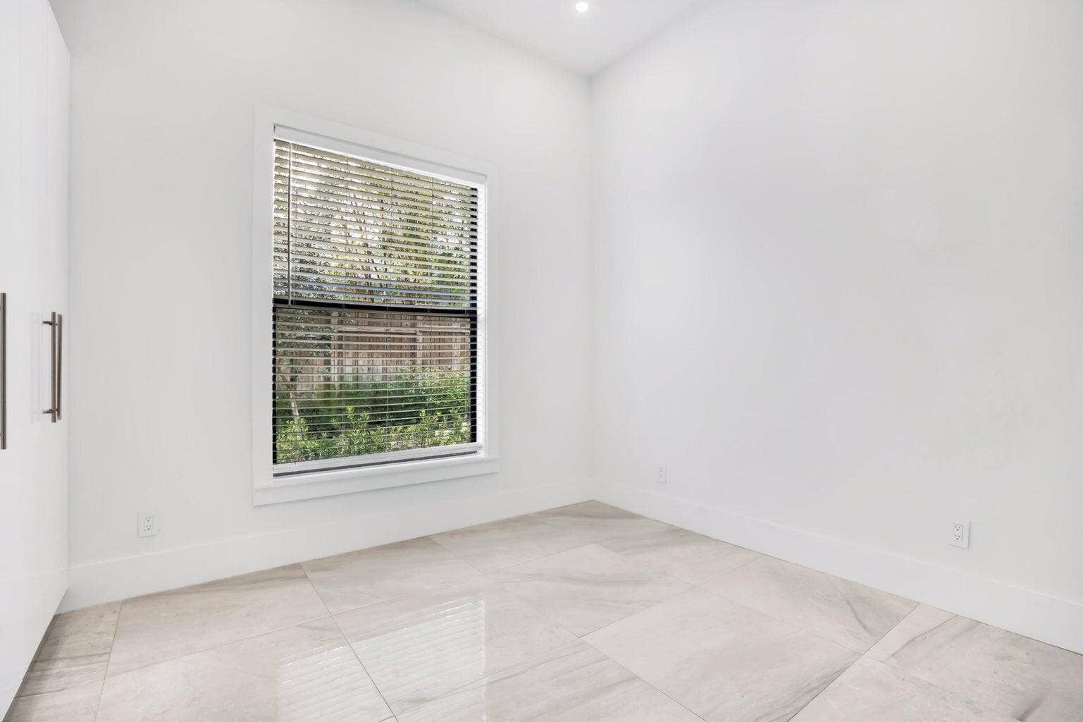 2517 Oceanview Avenue E, Delray Beach, Delray Beach, FL 33444 Recessed lighting, large window with blinds, light-toned tile flooring, and clean white walls