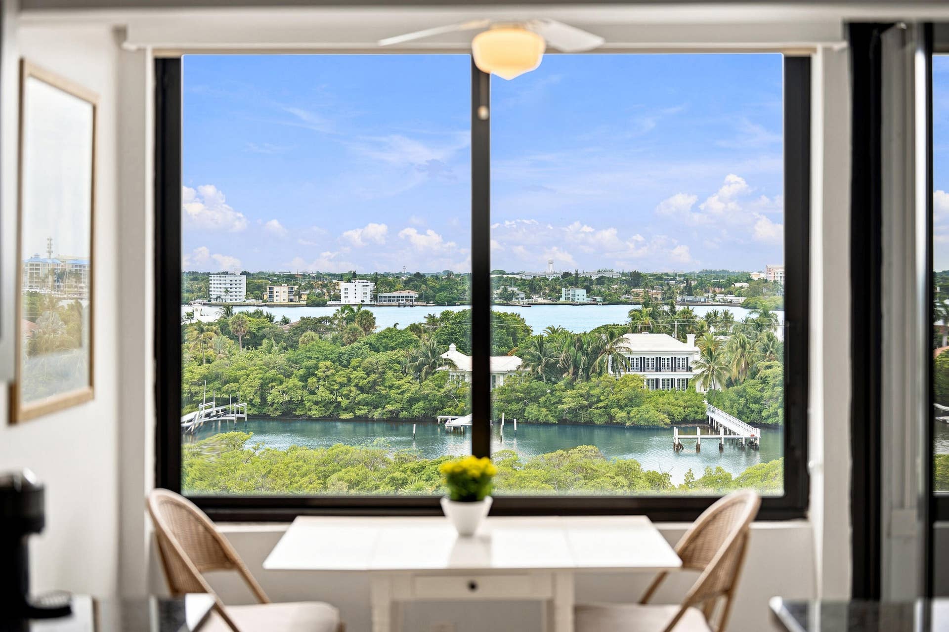 3589 S Ocean Boulevard, #808, South Palm Beach, FL 33480 Expansive window framing a water and city skyline panorama
