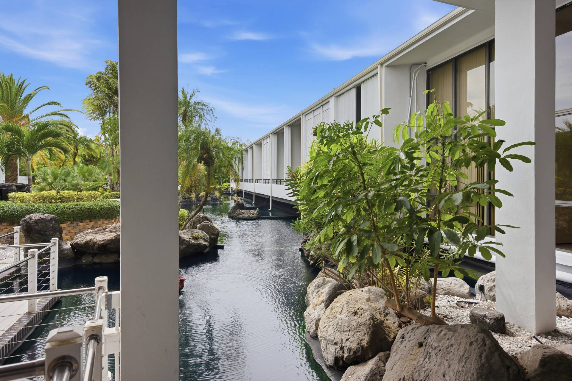 3589 S Ocean Boulevard, #808, South Palm Beach, FL 33480 Water feature with established tropical landscaping