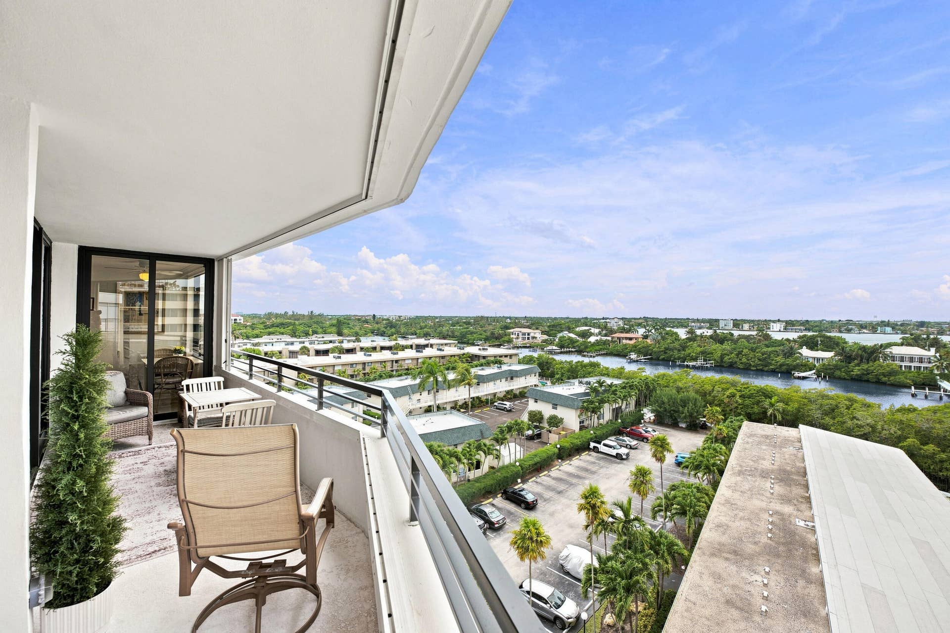 3589 S Ocean Boulevard, #808, South Palm Beach, FL 33480 Spacious balcony featuring a curved architectural design, concrete flooring, and a black metal railing