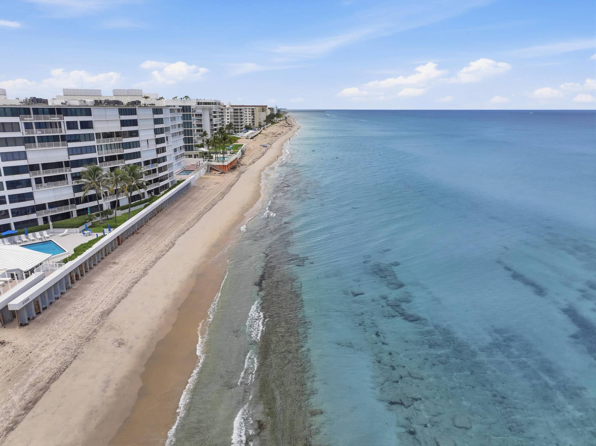 3589 S Ocean Boulevard, #808, South Palm Beach, FL 33480 Waterfront condominiums featuring a private swimming pool, direct beach access, and clear blue ocean waters