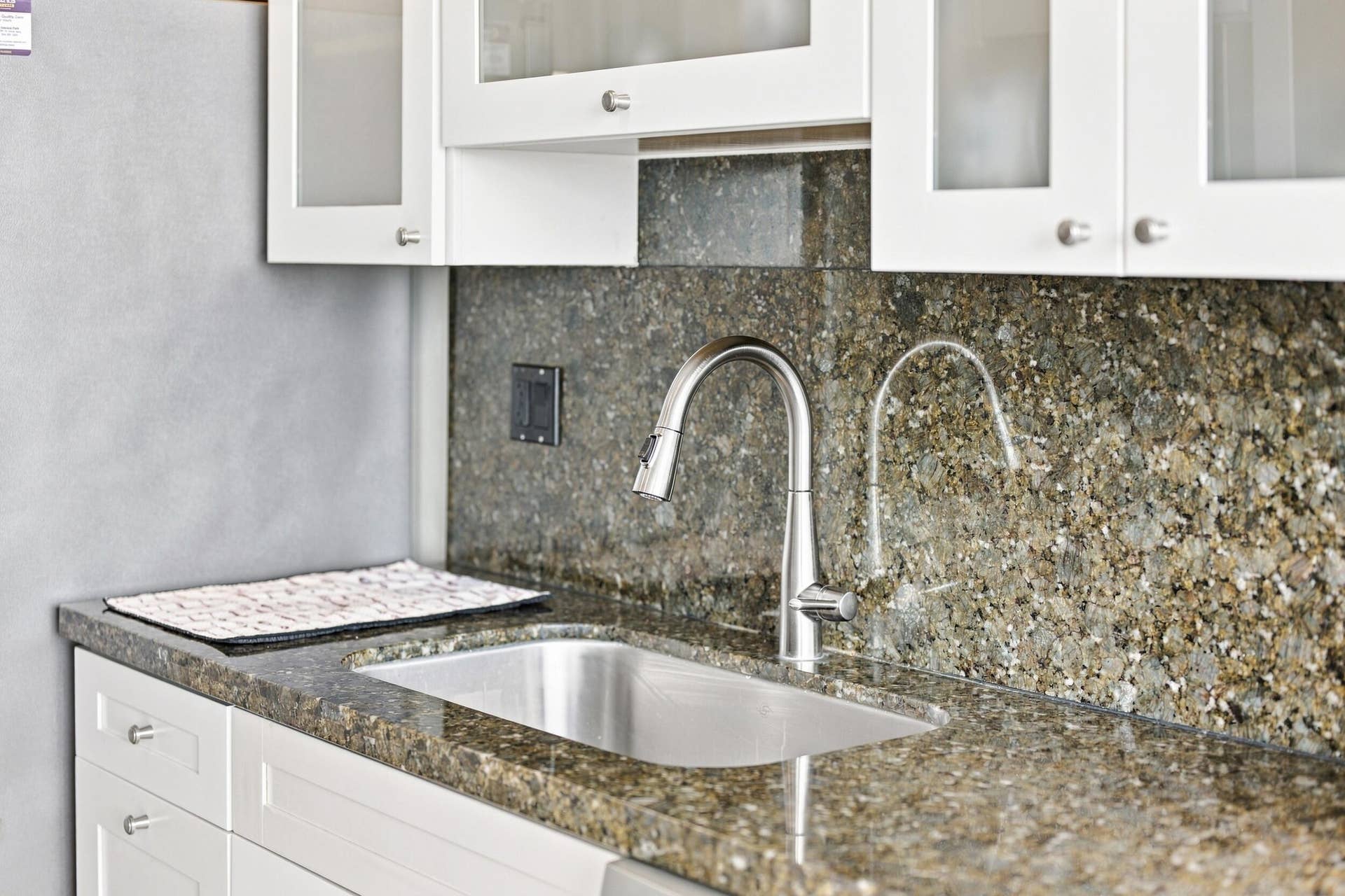 3589 S Ocean Boulevard, #808, South Palm Beach, FL 33480 Kitchen sink area featuring a stainless steel undermount sink, gooseneck faucet, and coordinating countertop and backsplash