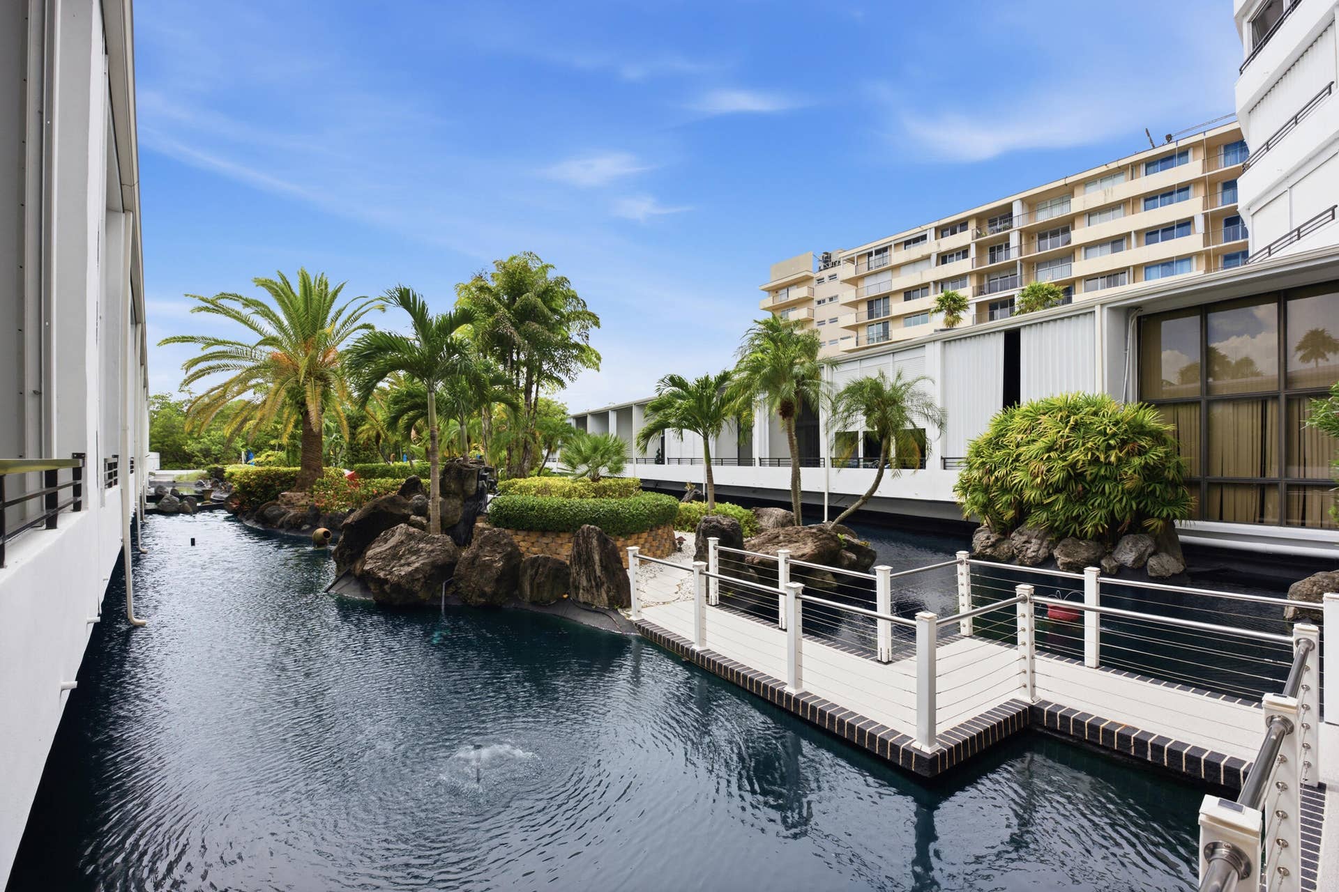 3589 S Ocean Boulevard, #808, South Palm Beach, FL 33480 Tranquil water feature with a stone island and lush tropical plantings