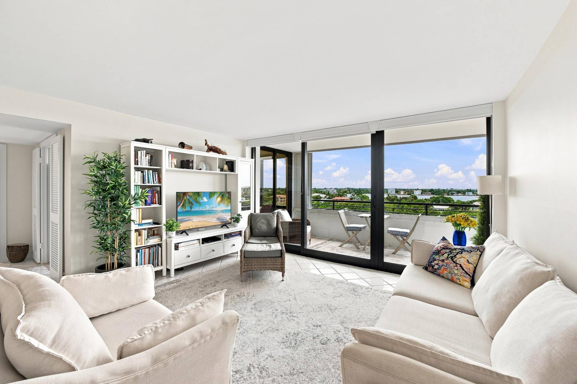 3589 S Ocean Boulevard, #808, South Palm Beach, FL 33480 Living area with spit bedrooms featuring extensive glass sliding doors opening to a private balcony