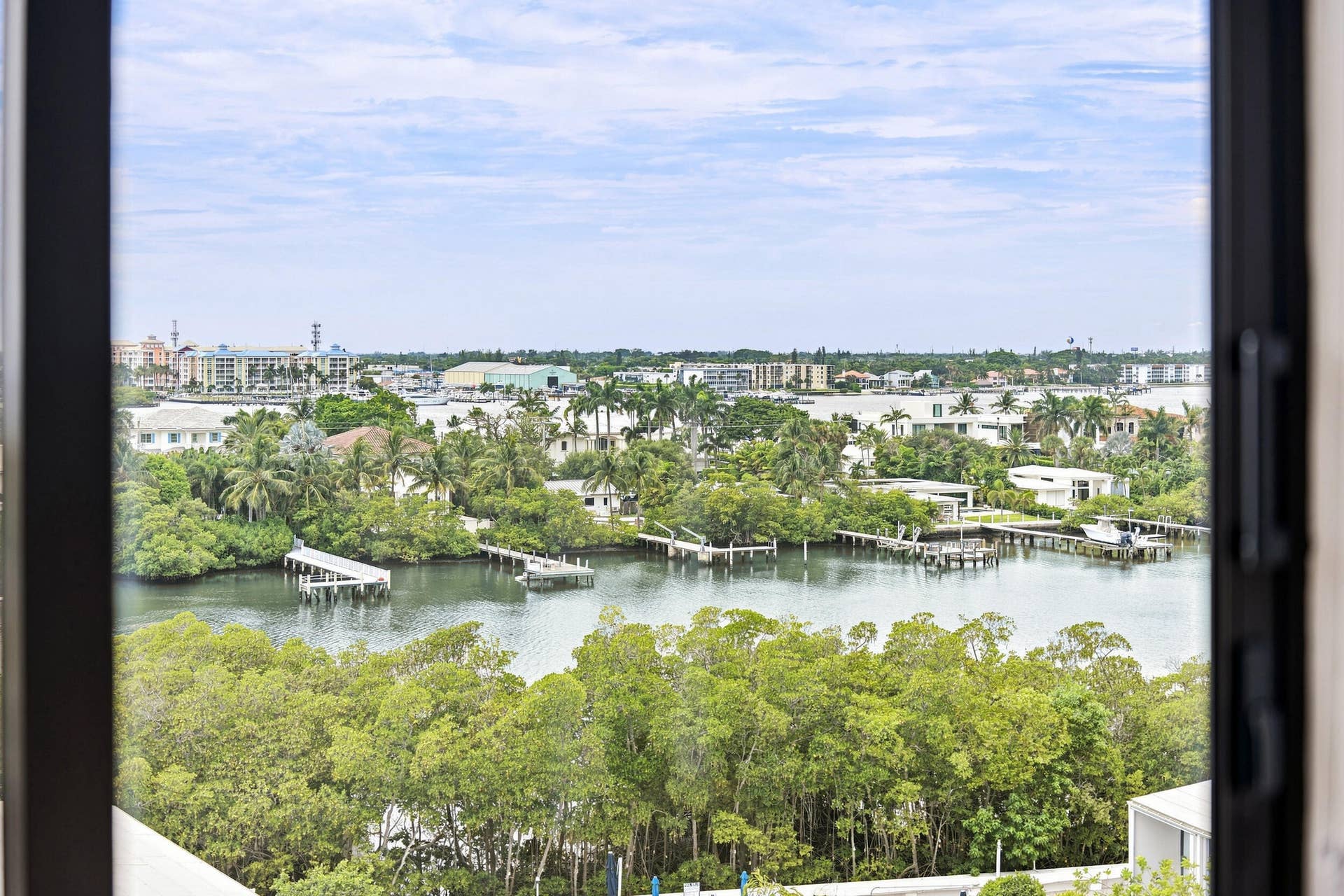 3589 S Ocean Boulevard, #808, South Palm Beach, FL 33480 Expansive water frontage with multiple docks and lush tropical foliage