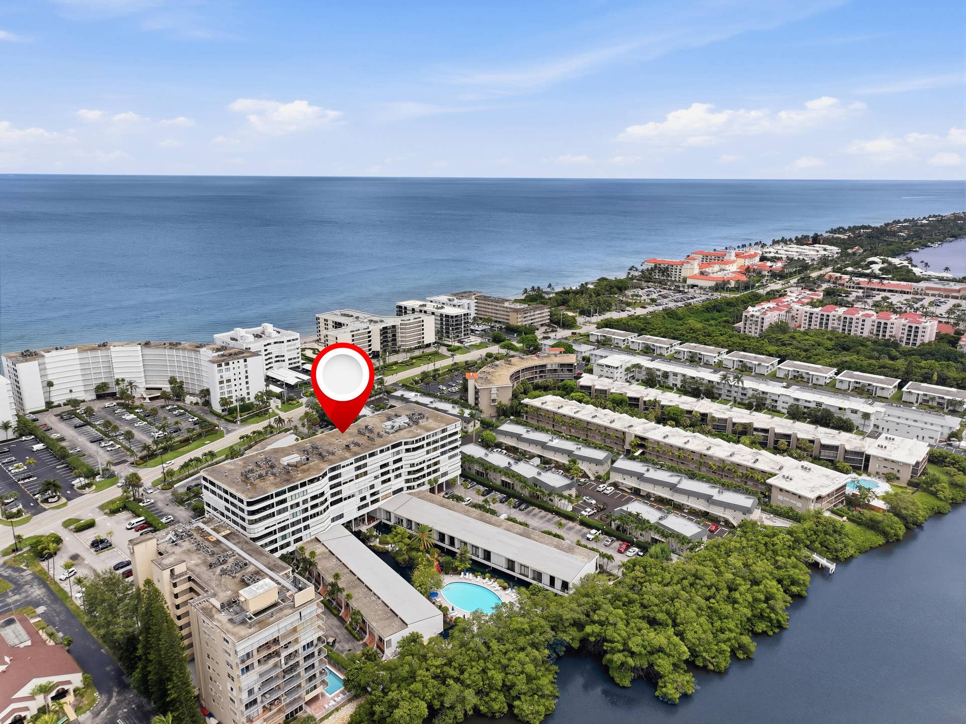 3589 S Ocean Boulevard, #808, South Palm Beach, FL 33480 Multi-story building with white exterior walls and horizontal window detailing