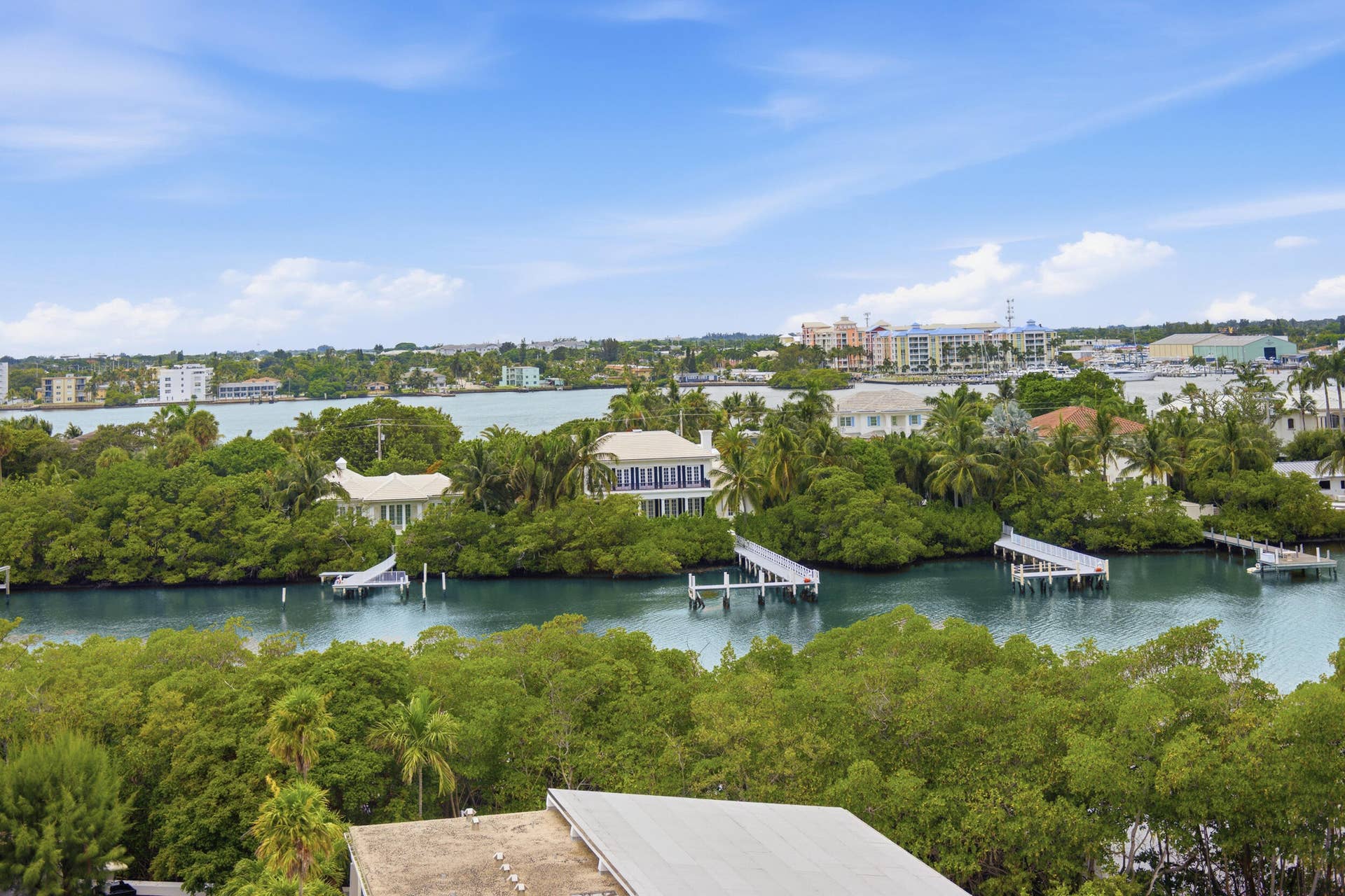 3589 S Ocean Boulevard, #808, South Palm Beach, FL 33480 Expansive waterfront scenery with multiple private docks and lush green foliage