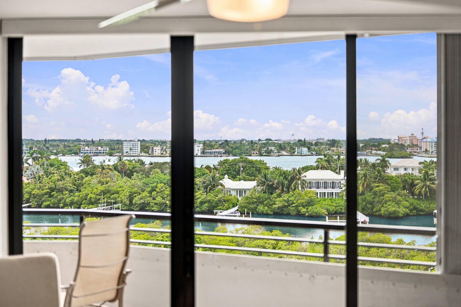 3589 S Ocean Boulevard, #808, South Palm Beach, FL 33480 Expansive windows frame panoramic water and cityscape scenery