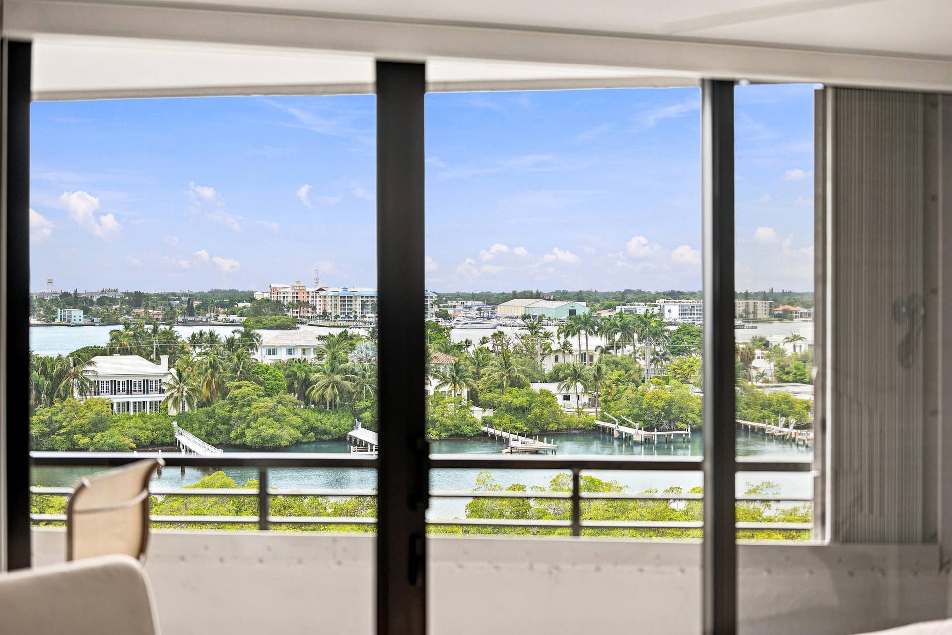 3589 S Ocean Boulevard, #808, South Palm Beach, FL 33480 Expansive waterfront scenery visible through large glass doors