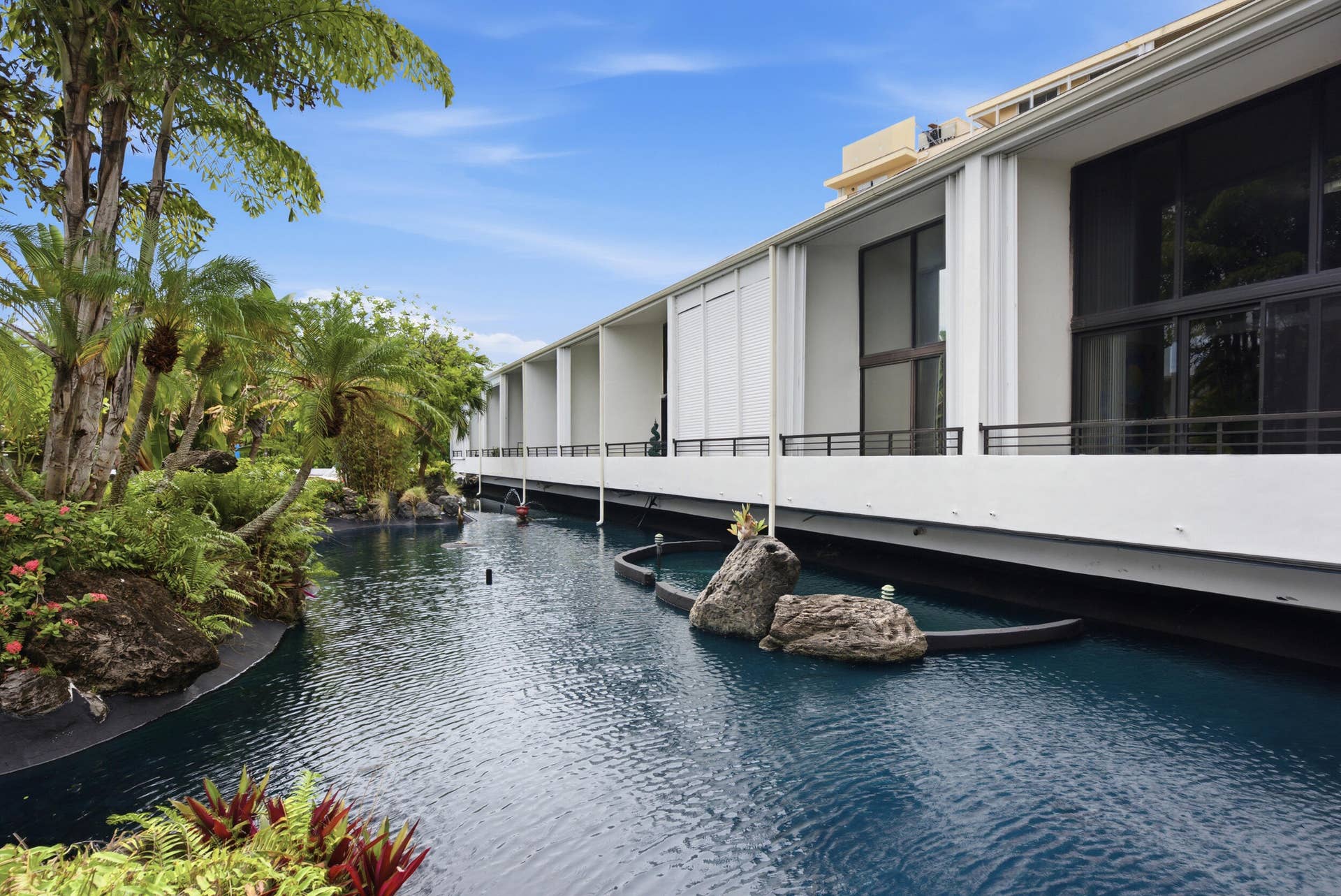 3589 S Ocean Boulevard, #808, South Palm Beach, FL 33480 Contemporary building facade with large glass panels and sleek white siding