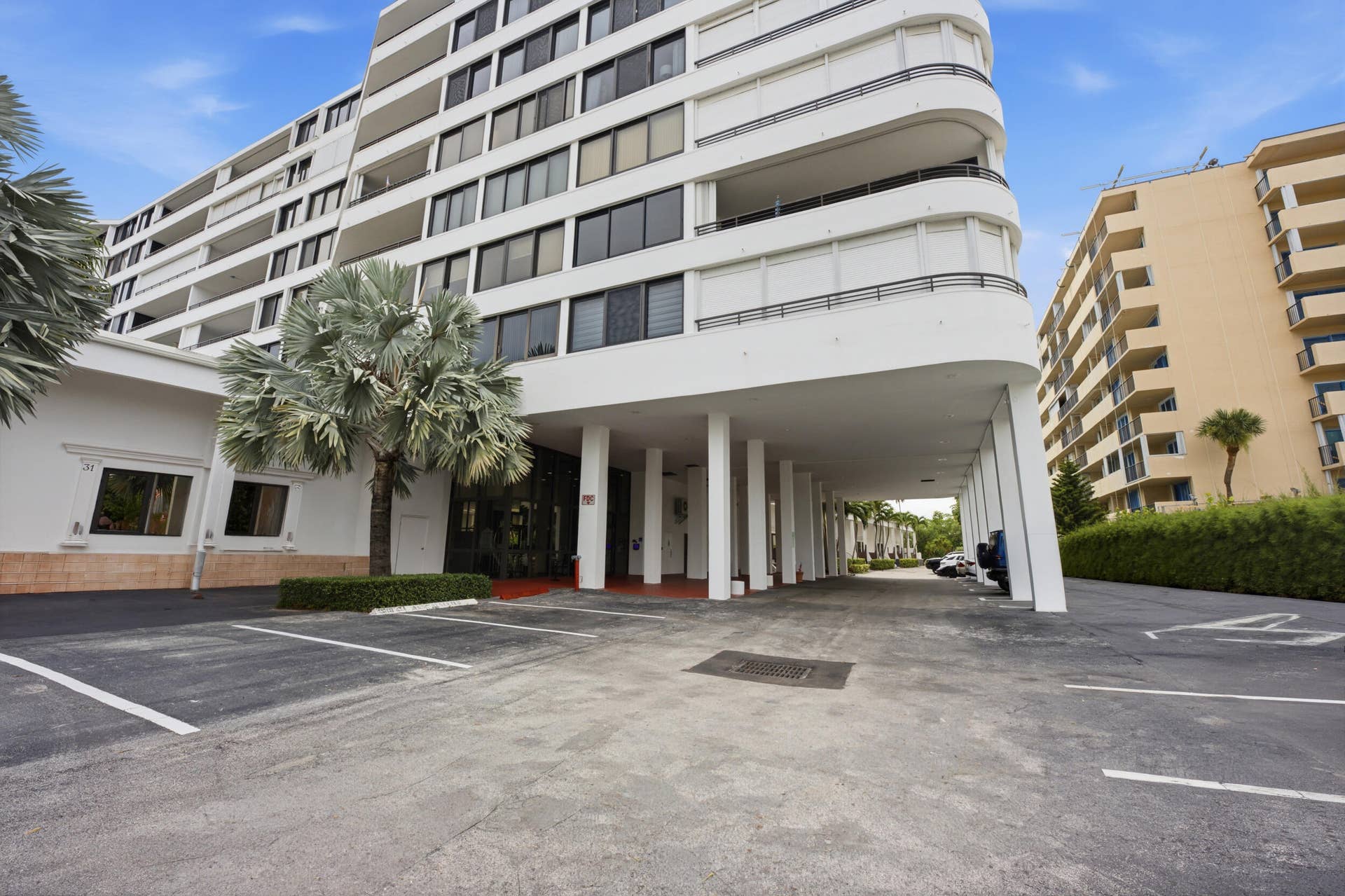 3589 S Ocean Boulevard, #808, South Palm Beach, FL 33480 Multi-story building featuring white facade, dark-tinted windows, and multiple balconies