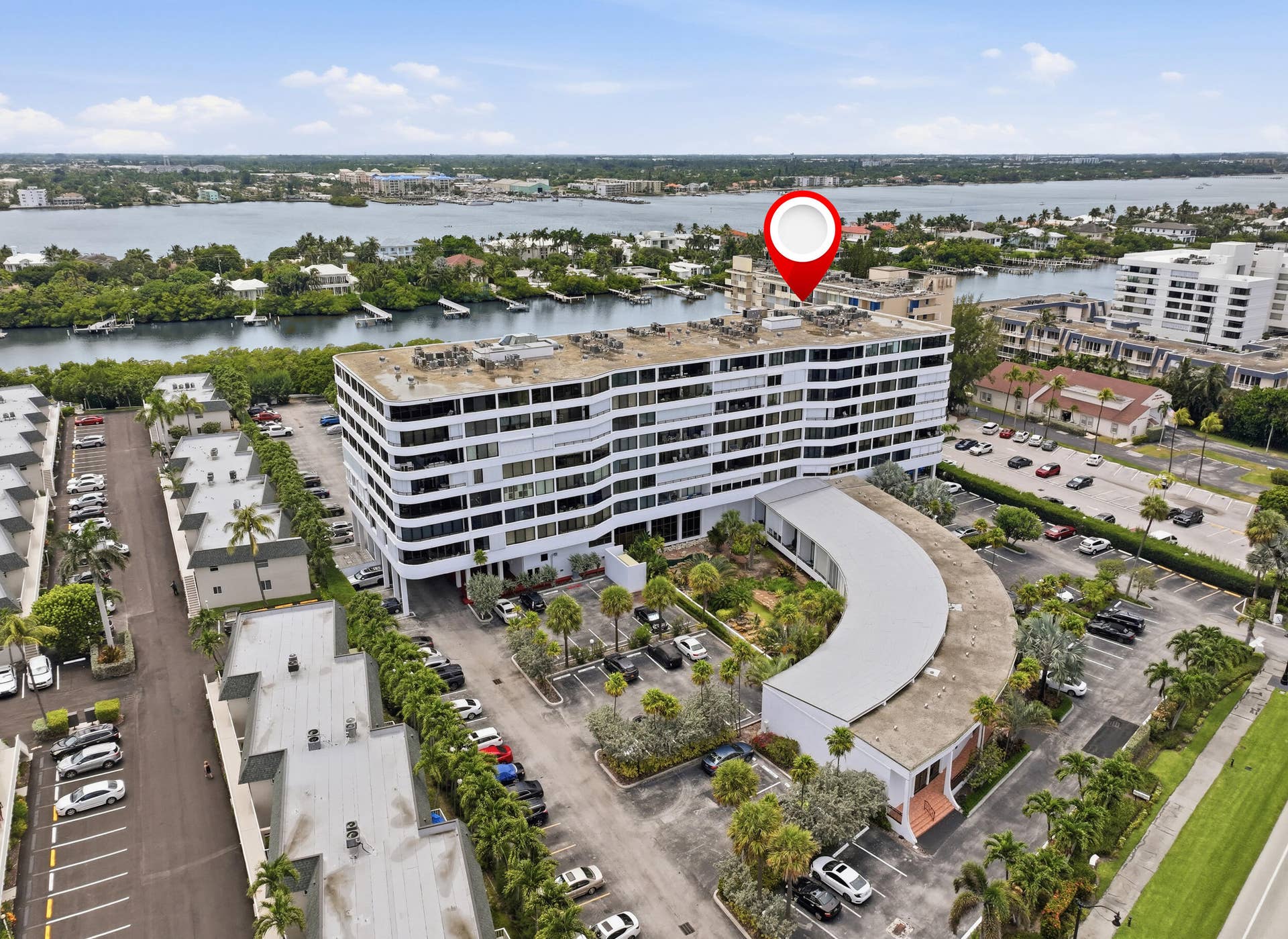 3589 S Ocean Boulevard, #808, South Palm Beach, FL 33480 Modern multistory building featuring white exterior finishes and multiple levels of balconies